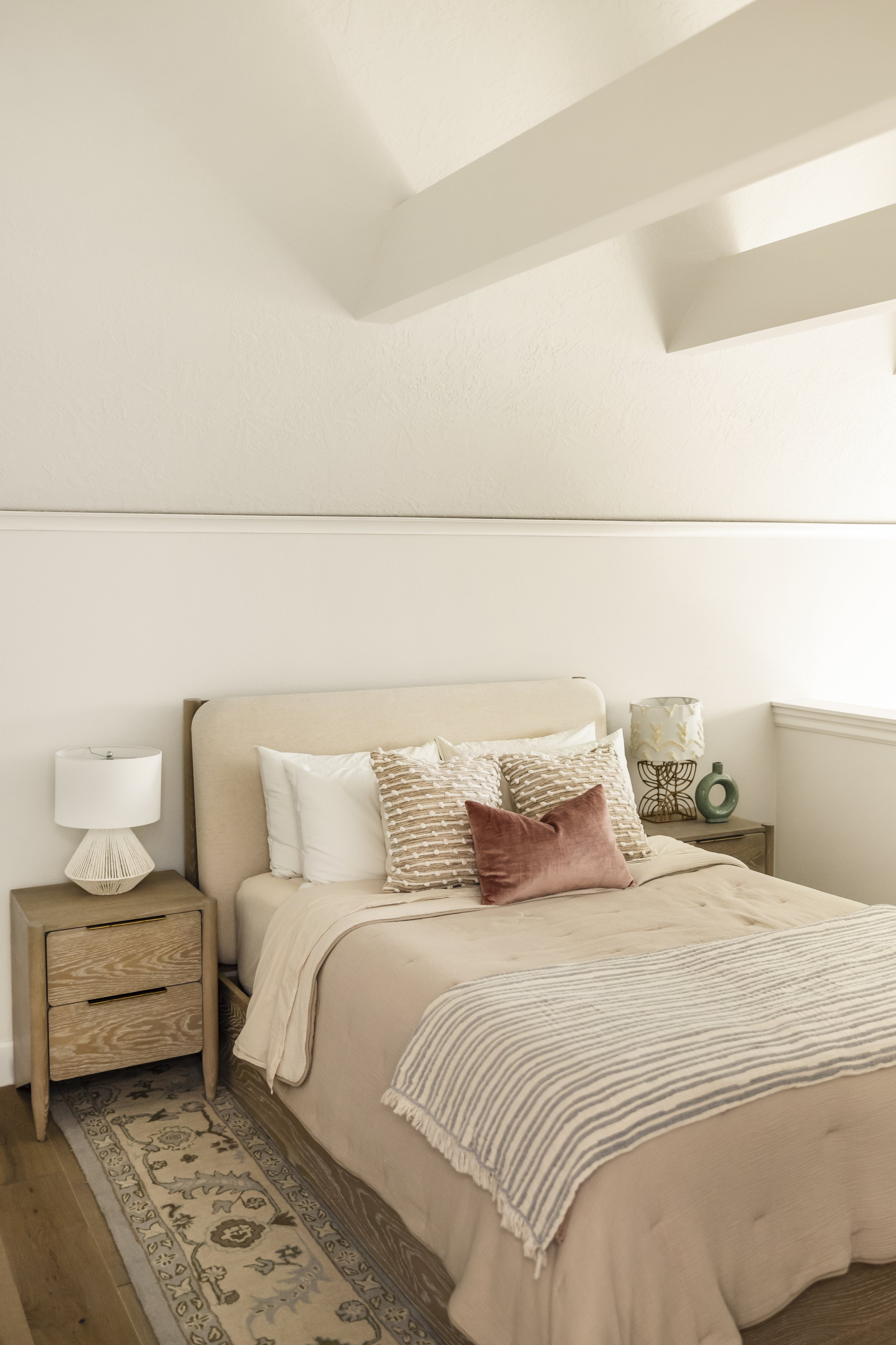 Girls bedroom with layered pink pillows in a loft style room, Vancouver WA Condo interior design