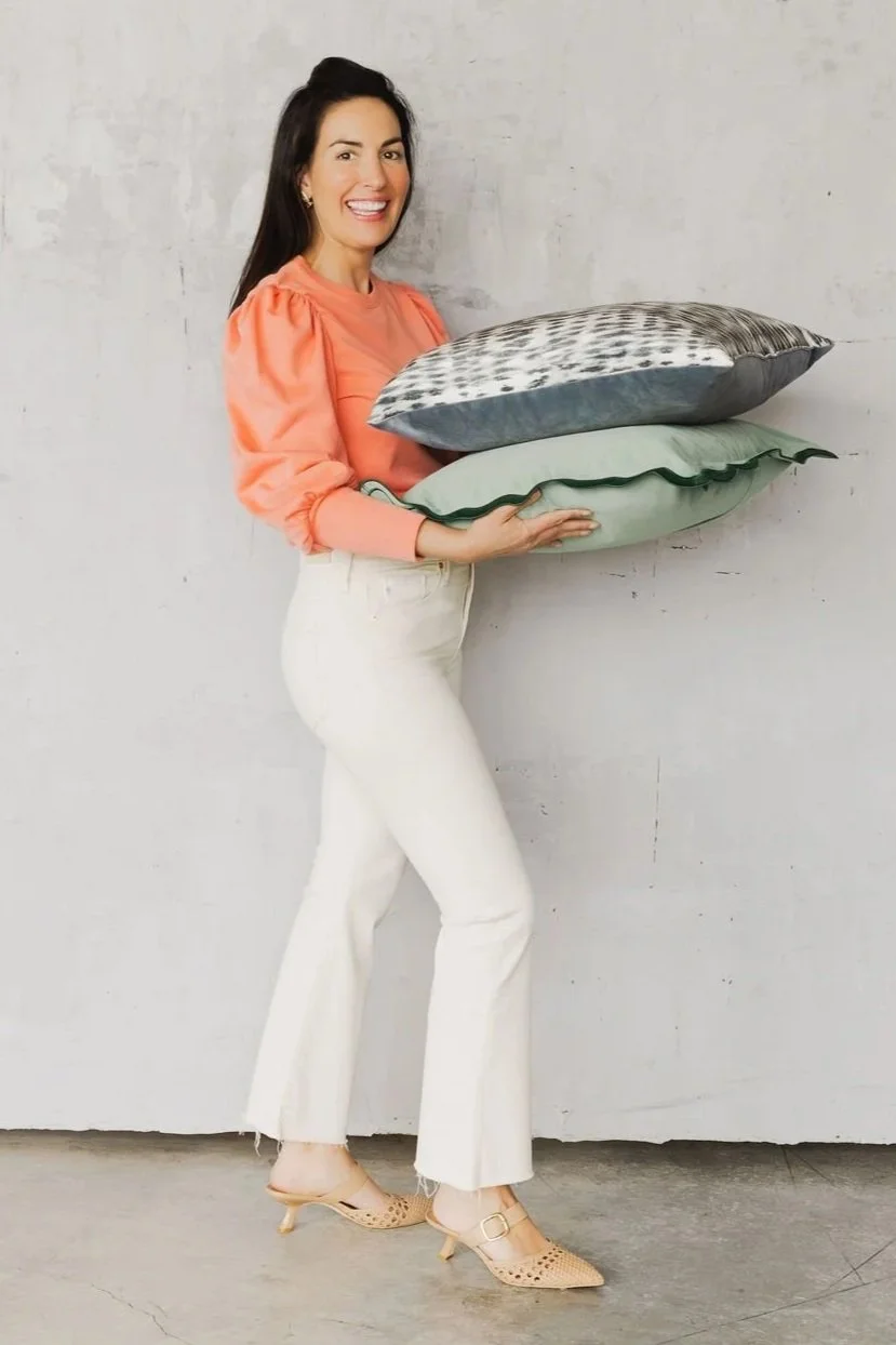 Refinement Wagner, Portland interior designer, holding decorative cushions for a client home in Hillsboro Oregon