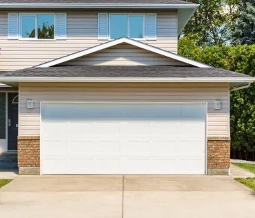 Front view of a suburban house with a double garage door