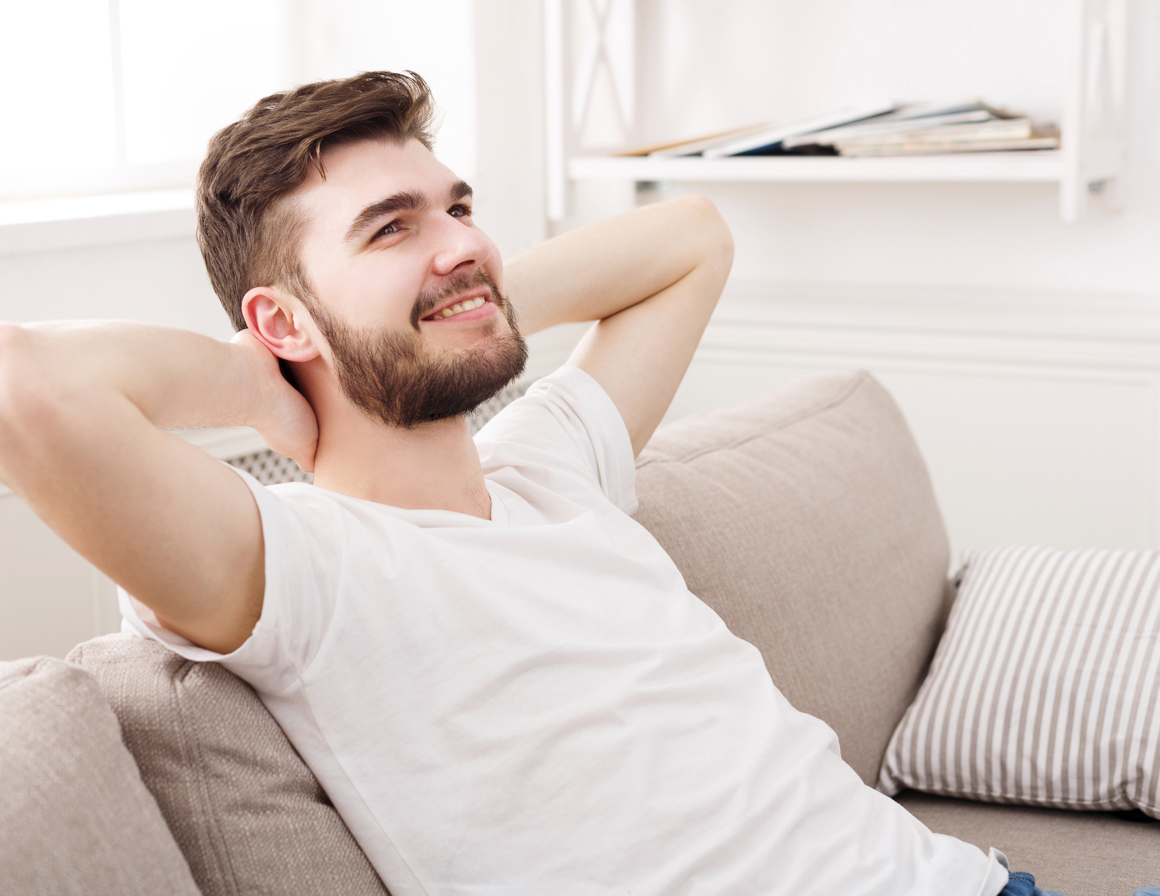 Man sitting on couch processing Ketamine experience in Ketamine-assisted psychotherapy integration session.