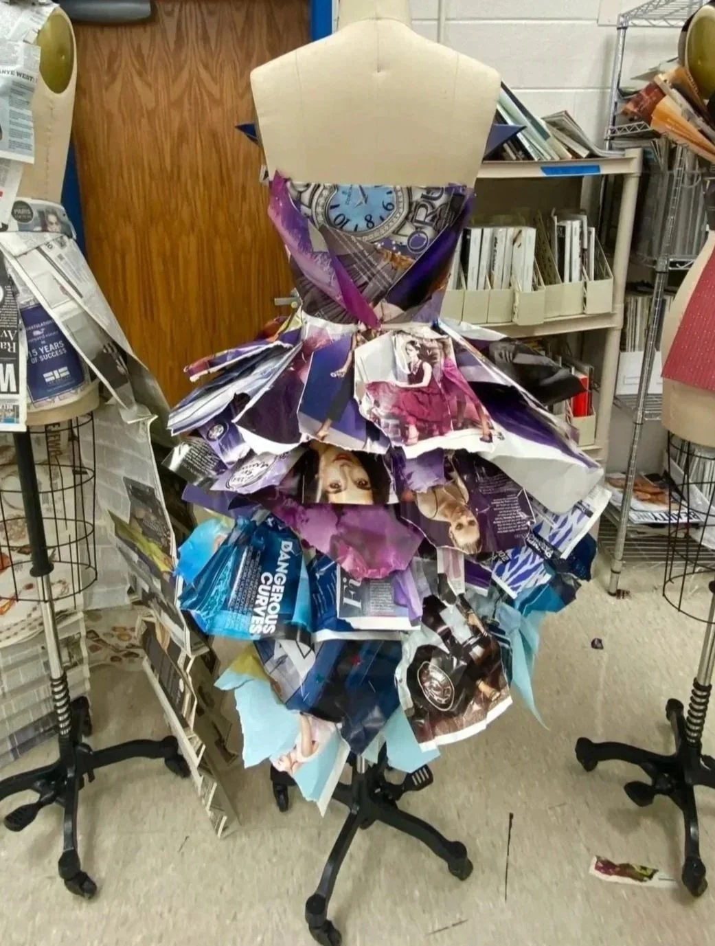 A back view of the magazine dress, revealing the structure and detailing of the piece.