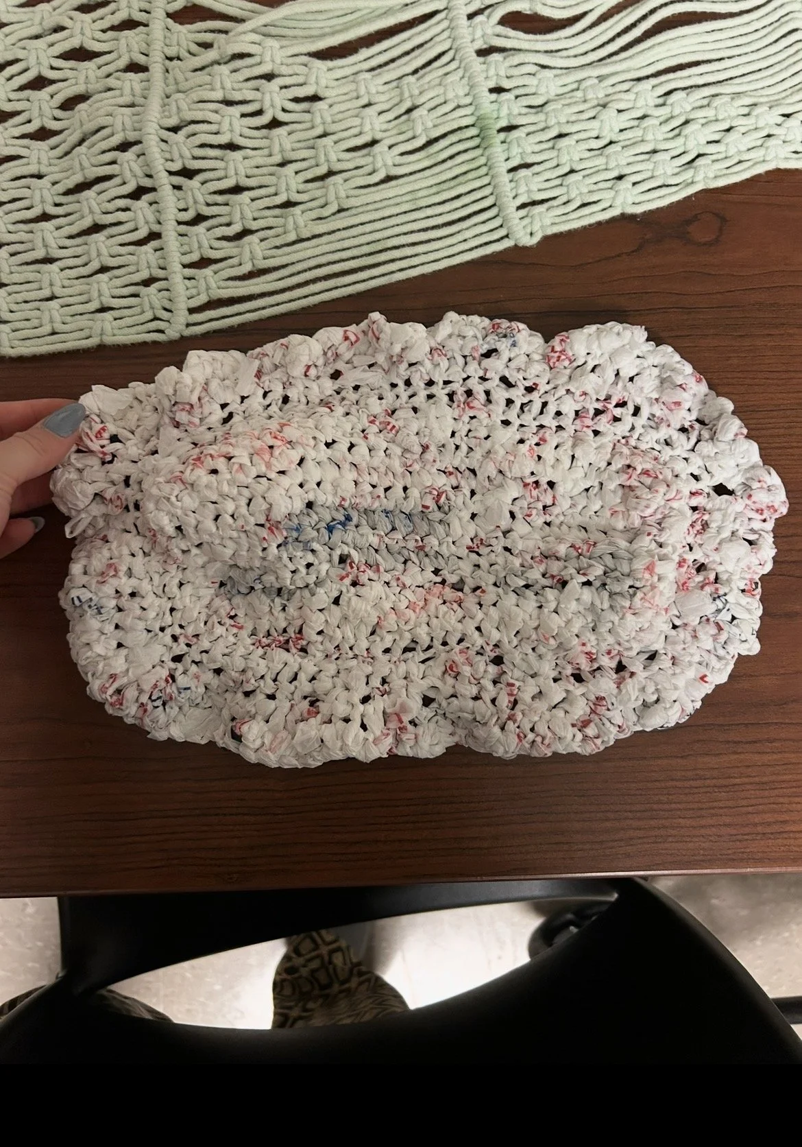 This placemat is crocheted from plarn, reshaping discarded grocery bags into continuous strands of usable material. The process transforms something disposable into an object with intention and renewed purpose.