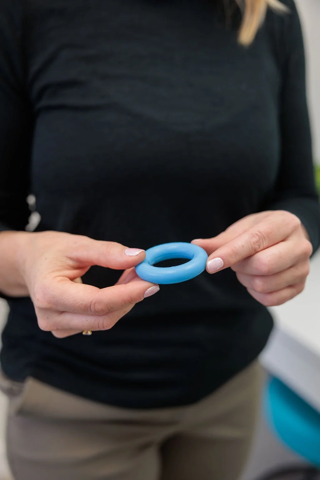 Pelvic health clinician holding a ring pessary used for pelvic organ prolapse support at Toronto Pessary Clinic.
