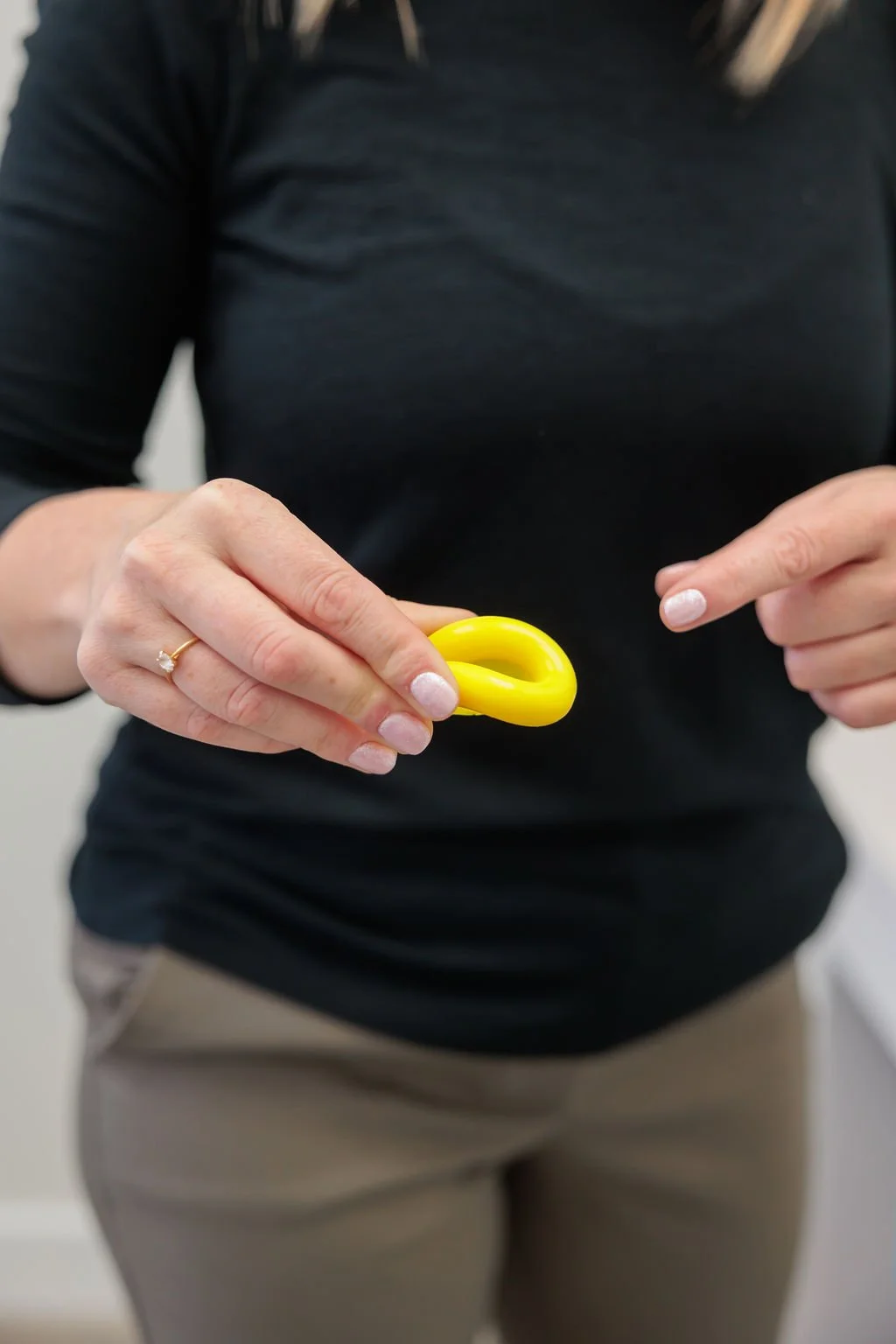 Pelvic health clinician holding a flexible ring pessary used for pelvic organ prolapse support at Toronto Pessary Clinic.