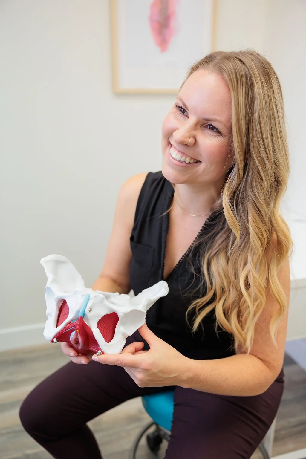 Pelvic health physiotherapist demonstrating a pelvic floor anatomy model during a patient education session at Toronto Pessary Clinic.
