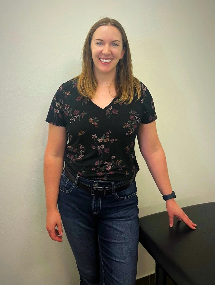 Pelvic health physiotherapy team member standing beside a treatment table at Toronto Pessary Clinic.