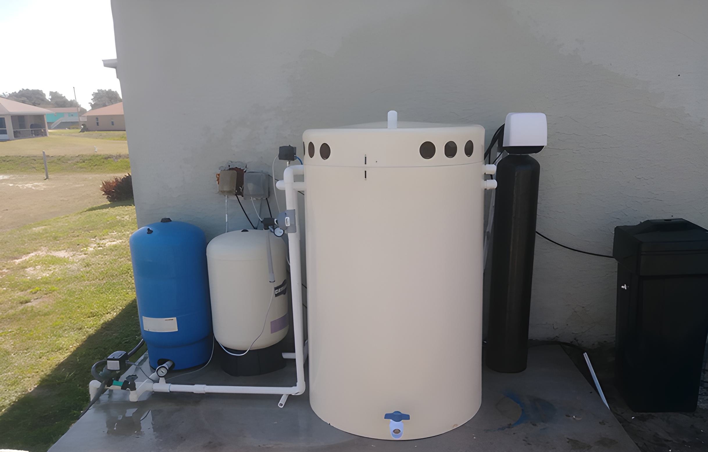 Outdoor water treatment with aeration, sulfur filter, iron filter, and softener to remove rotten egg smell, sulfur odor, hard water, iron stains, bacteria, and discoloration. RO for purified water.