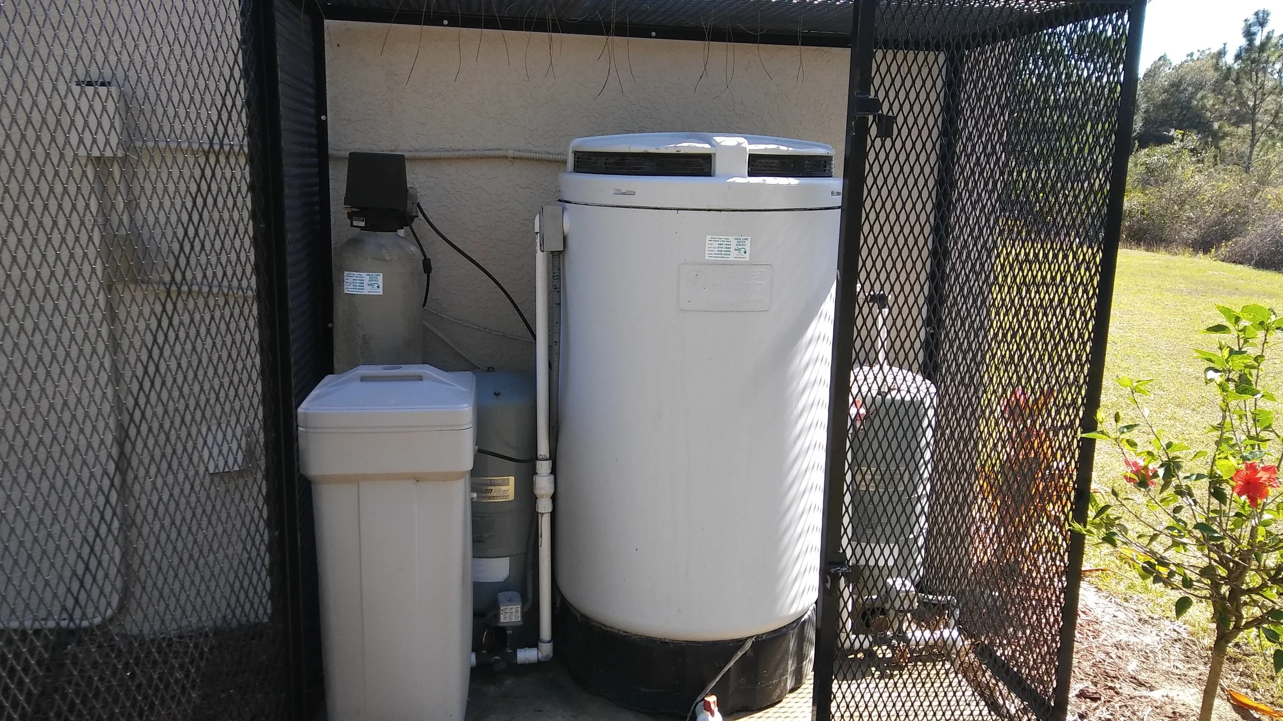 Outdoor water treatment with aeration, sulfur filter, iron filter, and softener to remove rotten egg smell, sulfur odor, hard water, iron stains, bacteria, and discoloration. RO for purified water.