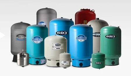 Collection of various sized water pressure tanks in gray, blue, white, green, and red colors.