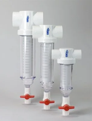 Three white spin down filters with transparent bodies and orange valves, arranged vertically on a gray background.
