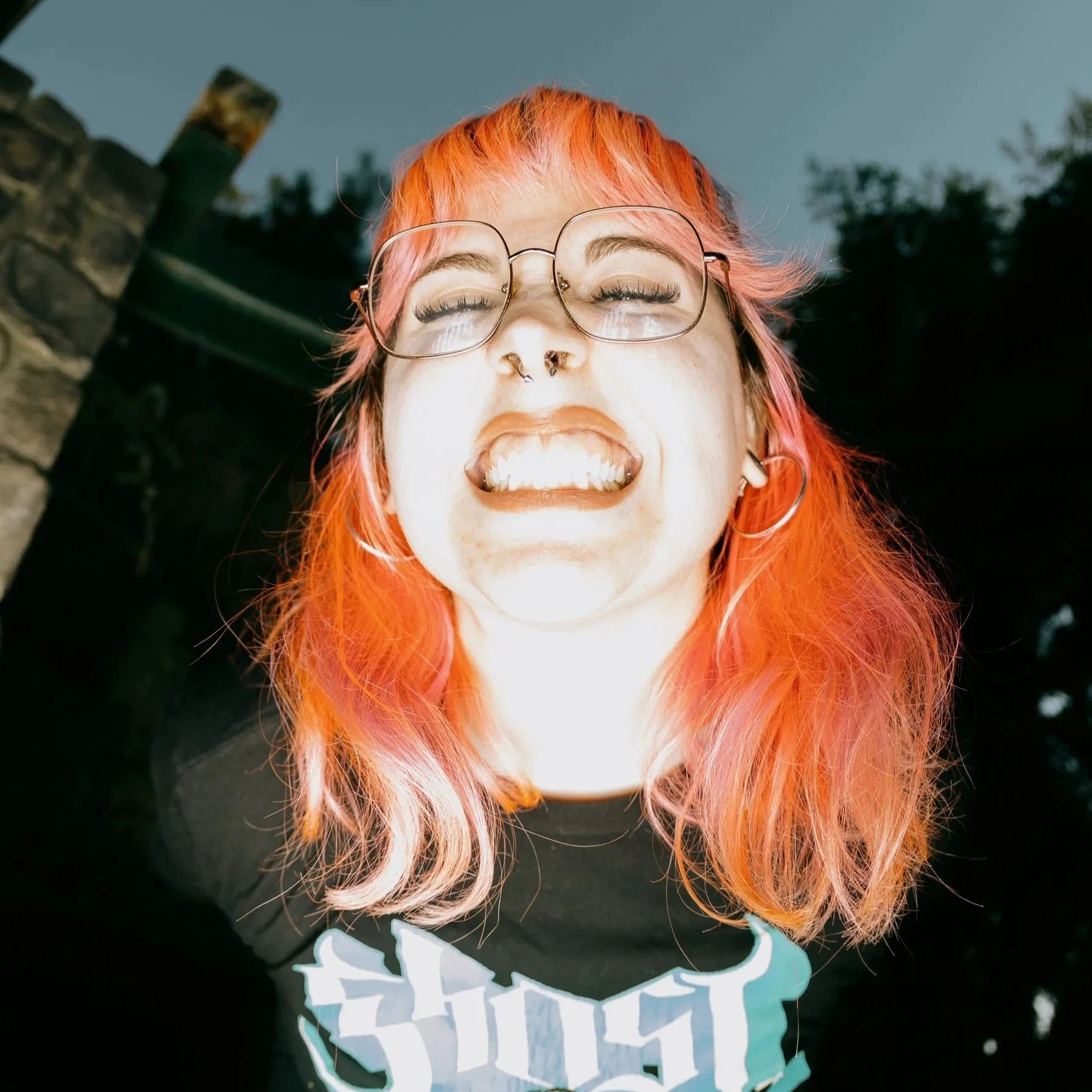 a photo of Cierra smiling, taken from below with harsh flash