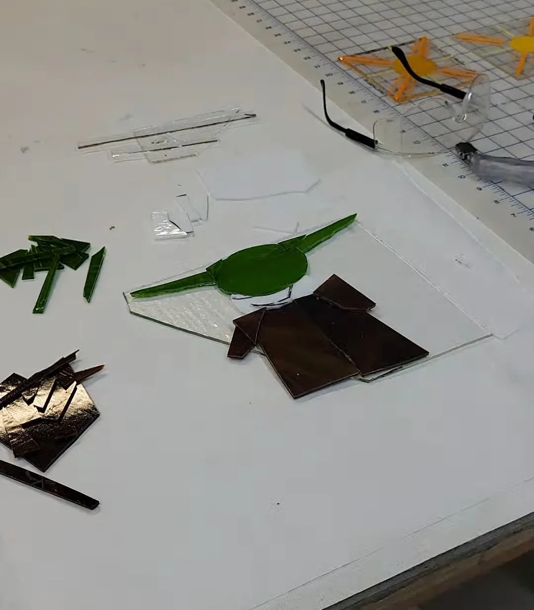 At this point I am glueing all the pieces together so I can start adding the last details to the background.