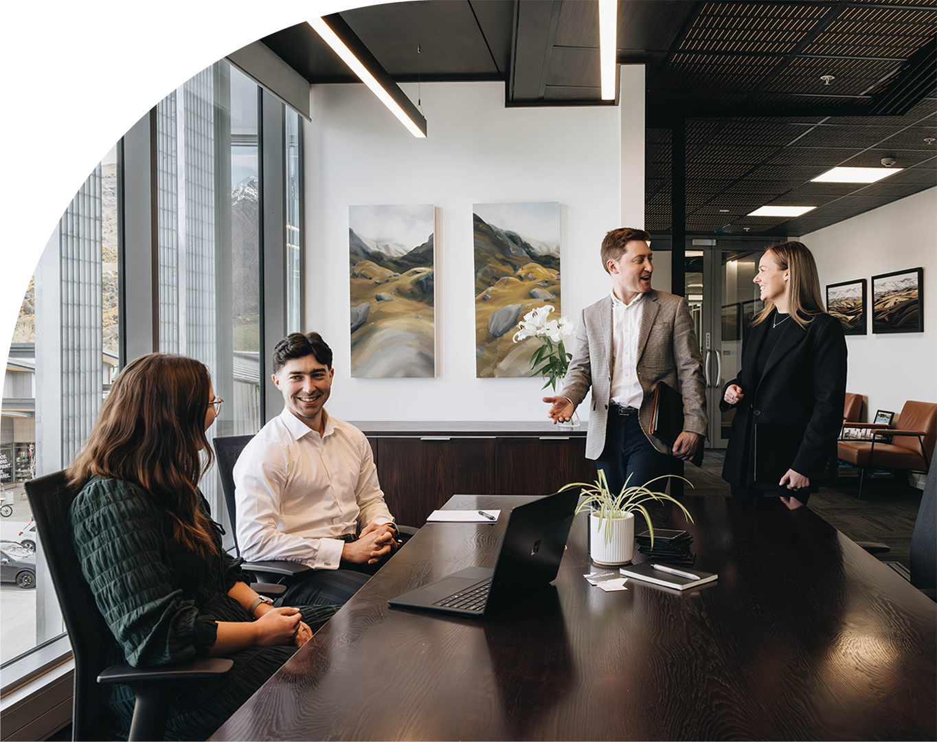 People sitting around meeting room table