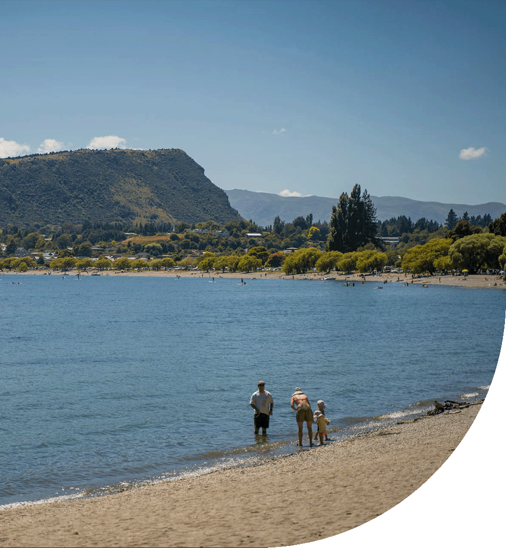 People standing by water on Wanaka lakefront