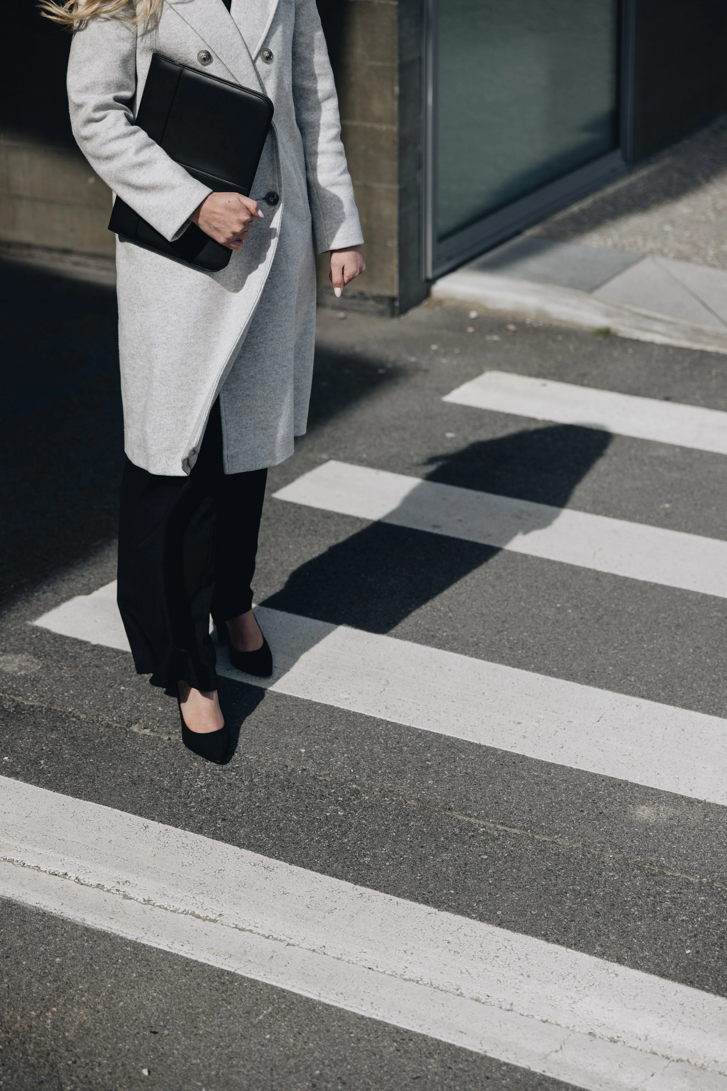 Person holding notes on crossing