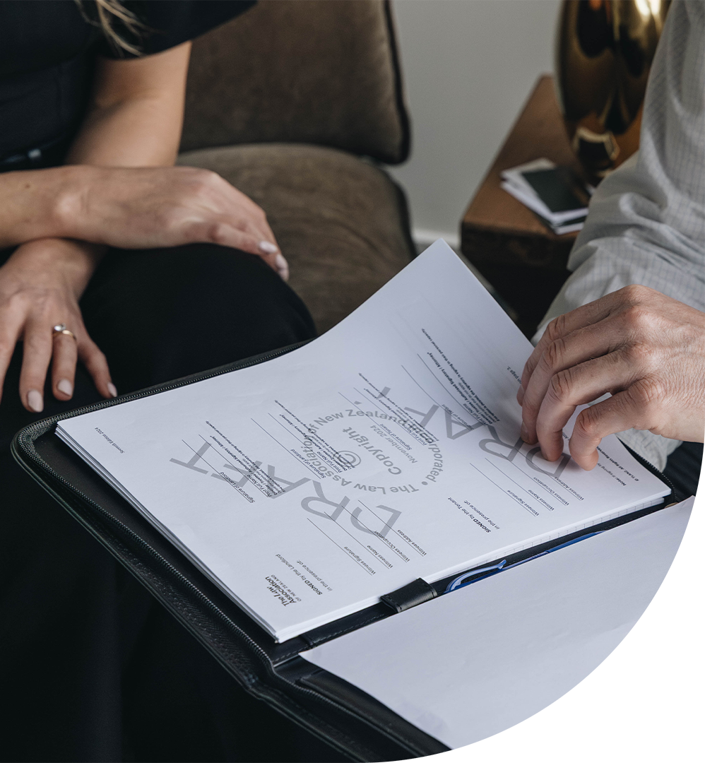 Two people discussing a legal document