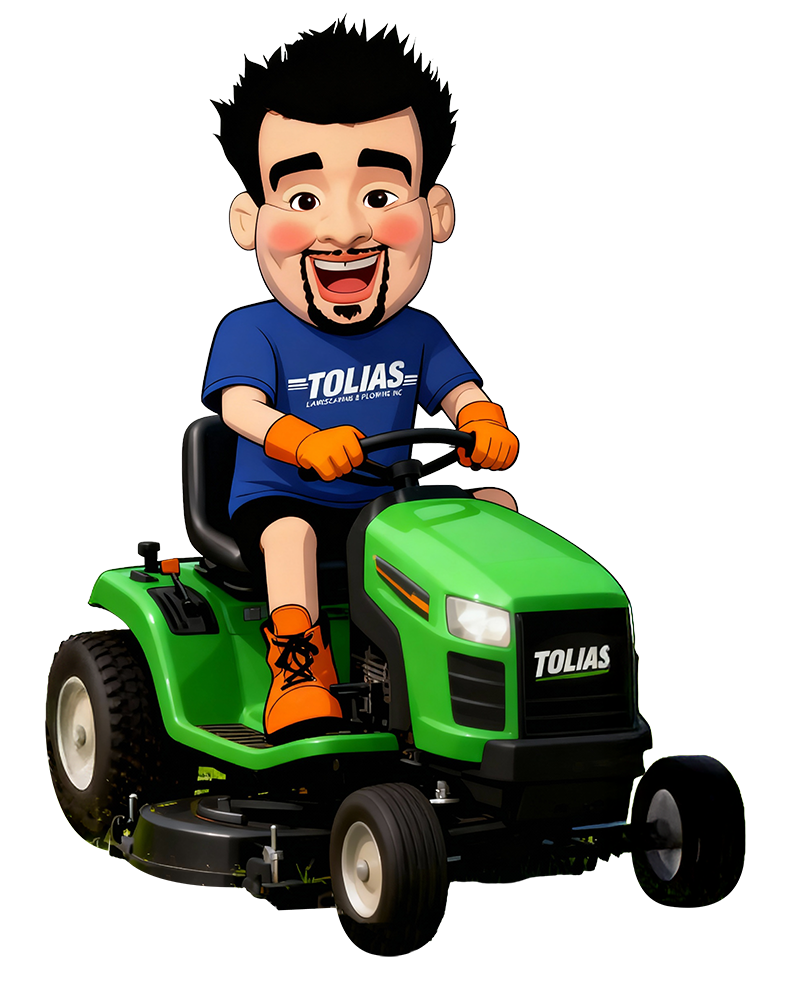 Tolias Mascot sitting on a green riding lawn mower labeled 'TOLIAS'.