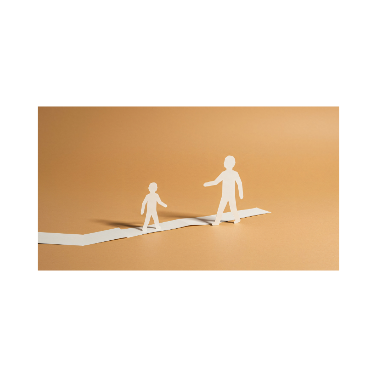 Paper cutouts of a smaller and larger figure walking on a strip of paper with a brown background.