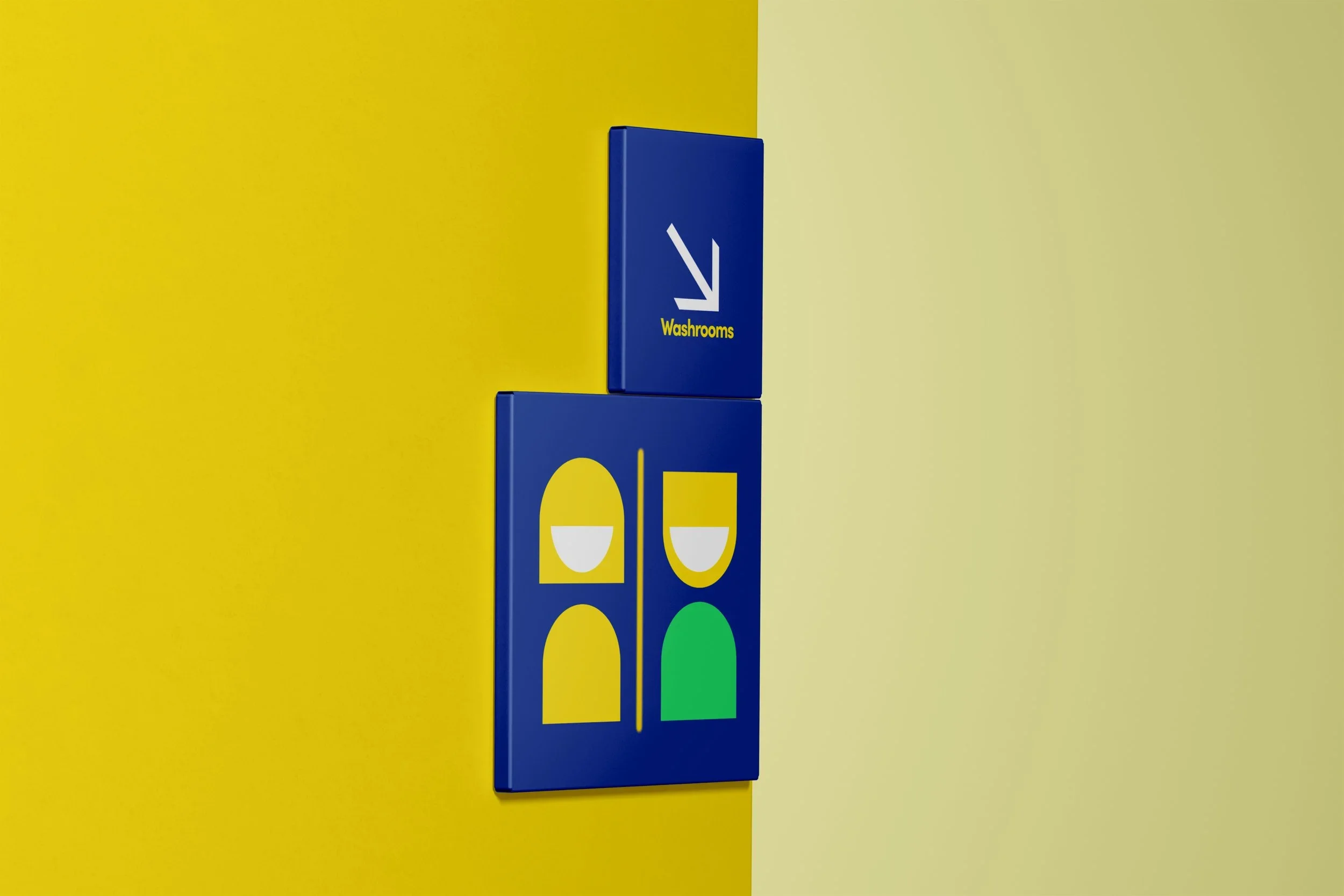 Colorful wall signs indicating the location of washrooms, with symbols of two people and arrows pointing down.