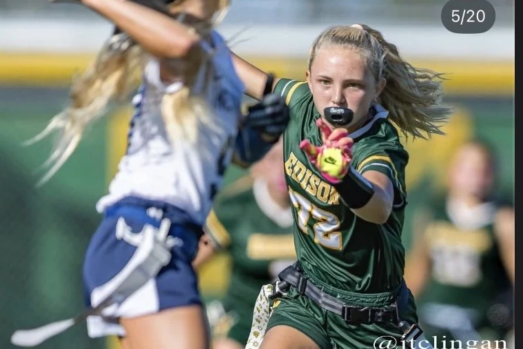 Addie Bond, Freshman women's flag football player at Edison HS. Image of Addie mid-game guarding another player.
