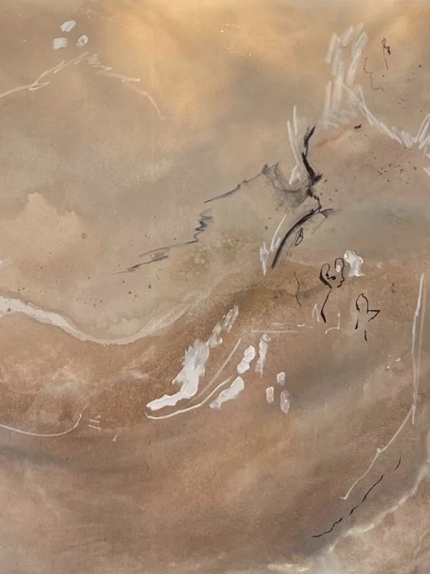 Close-up of a textured surface with abstract marks, scratches, and patches of white and black ink or paint.