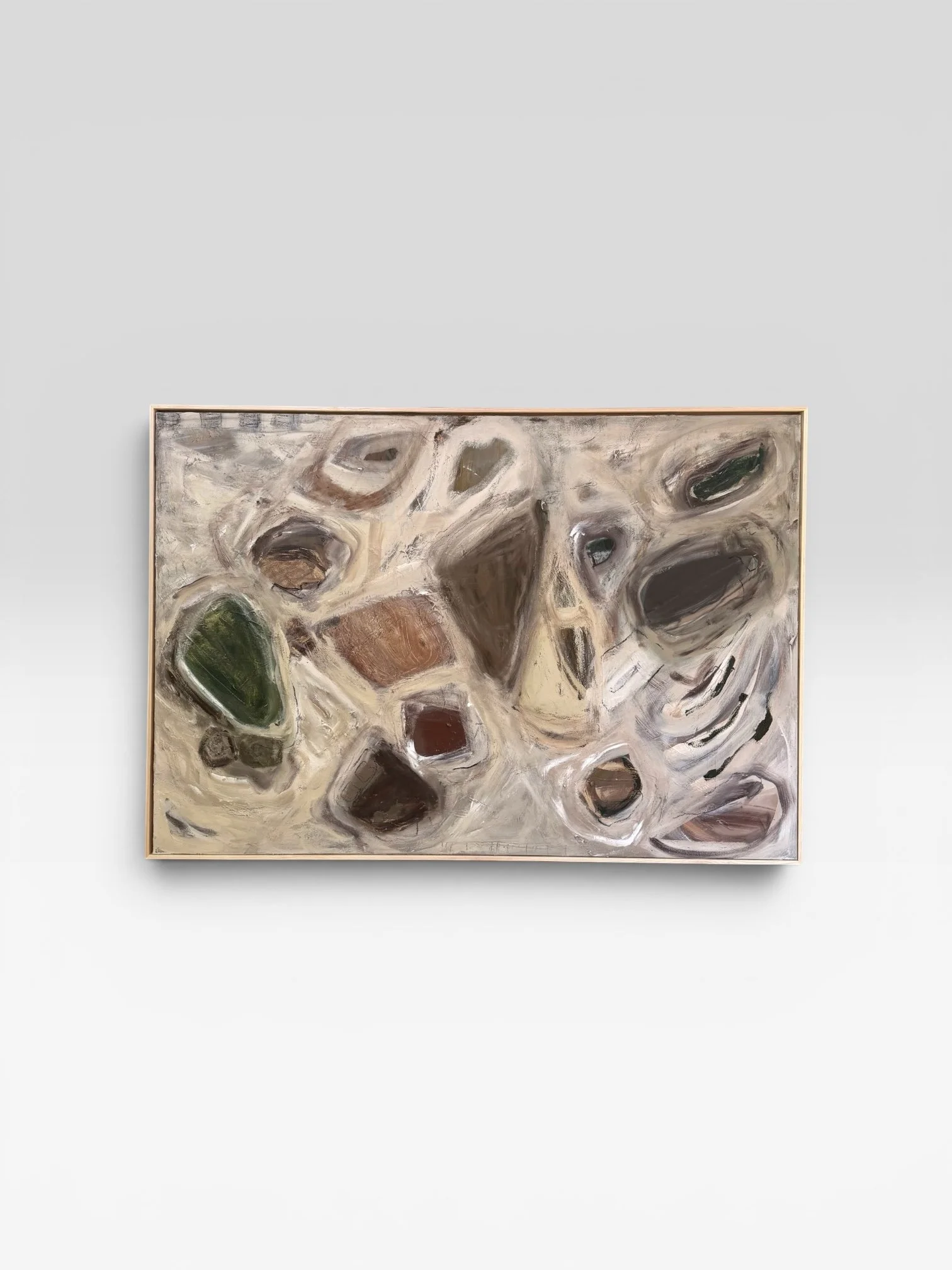 Abstract painting with various oval and irregular shapes in earthy tones, framed and displayed on a white wall.