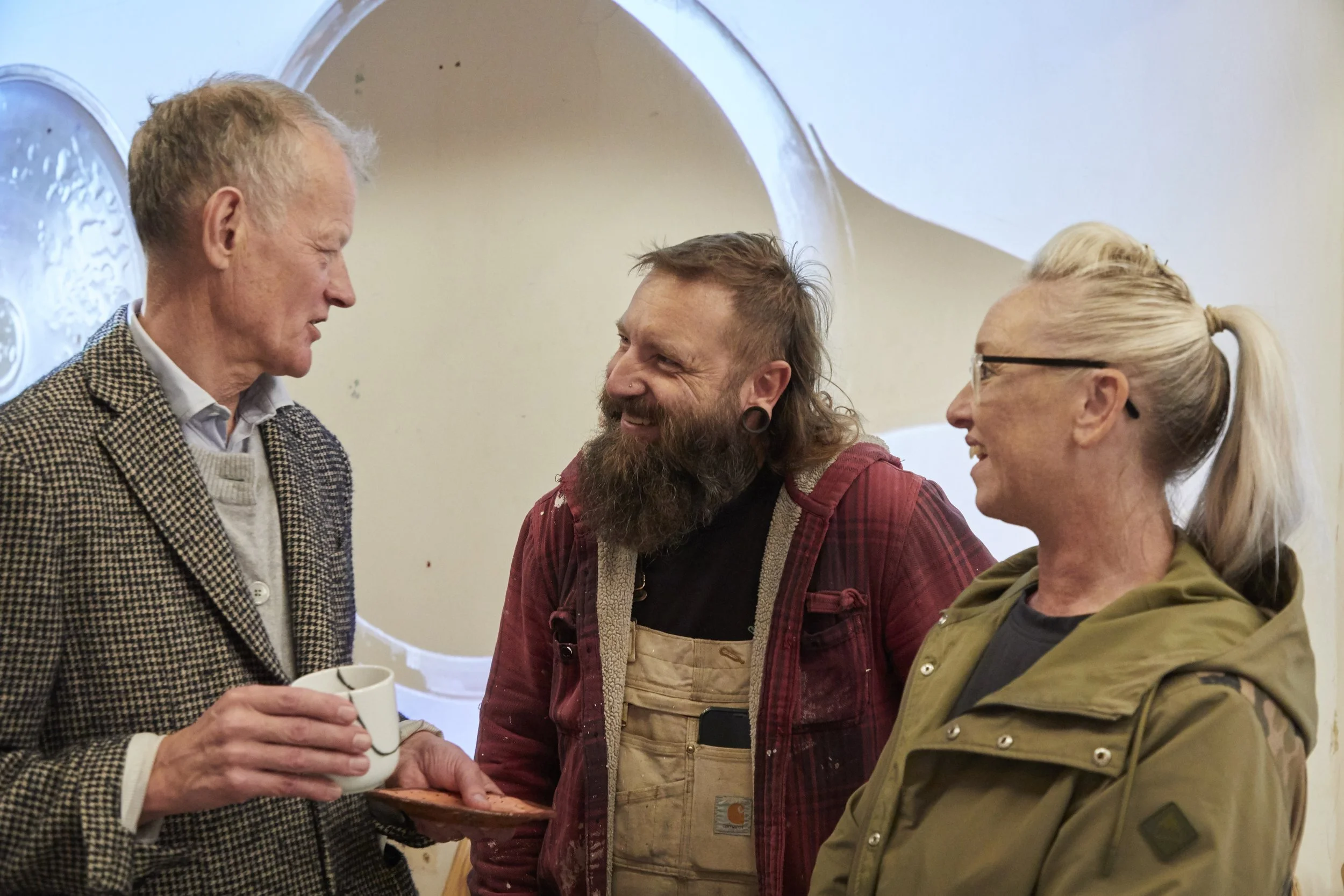 A photograph of Crispin Kelly with guests at the teaparty event in CLAY 1A's building in Ipswich.