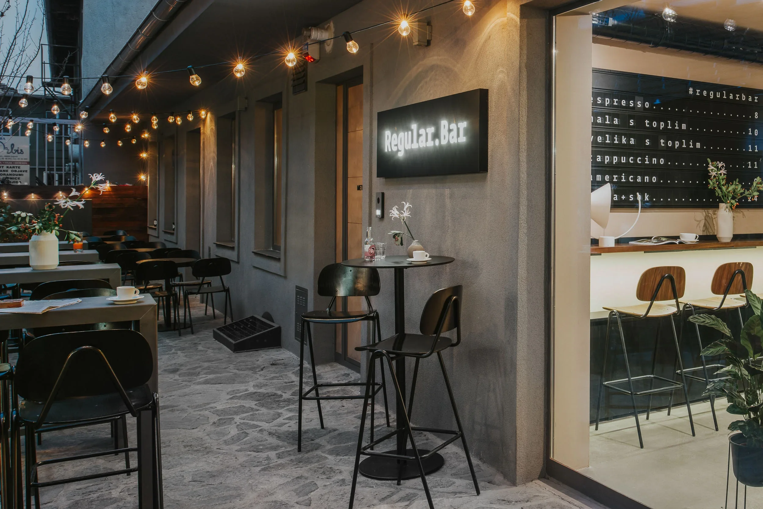 Terrace seating at Regular Bar overlooking British Square alleyway