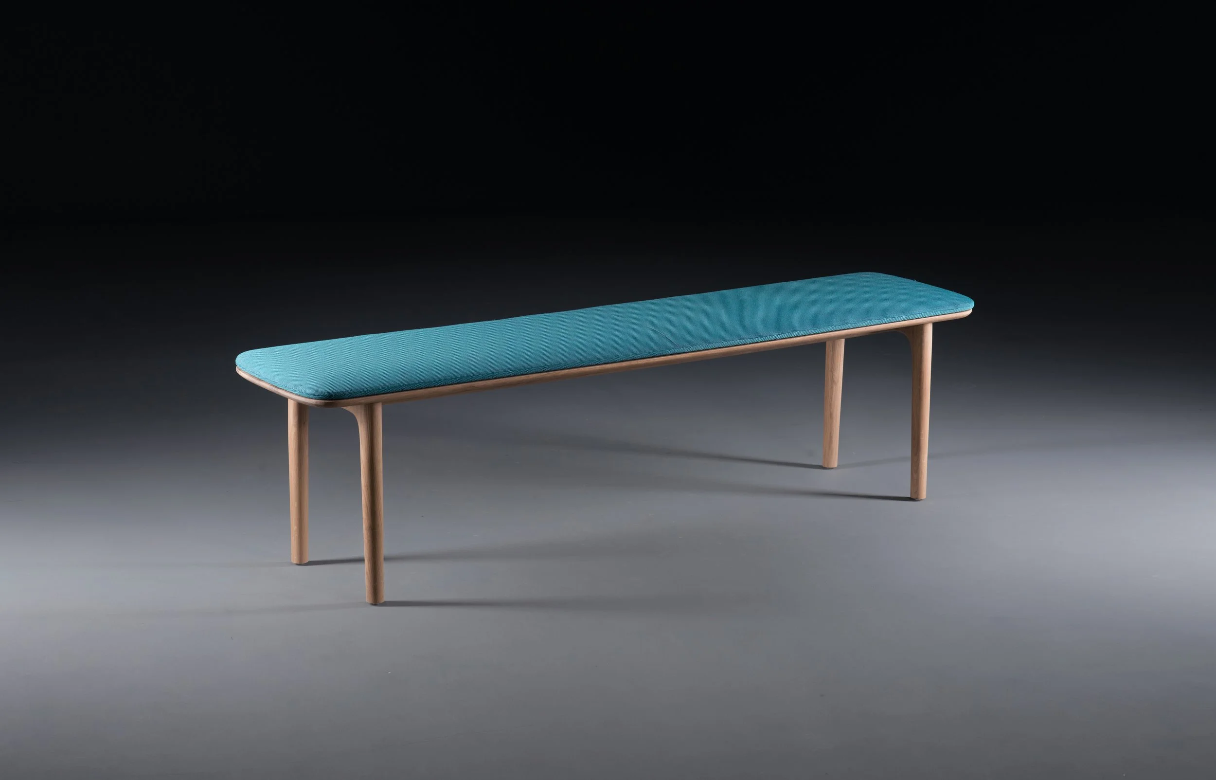 Side view of the Neva bench emphasizing its slim profile and solid wood construction.