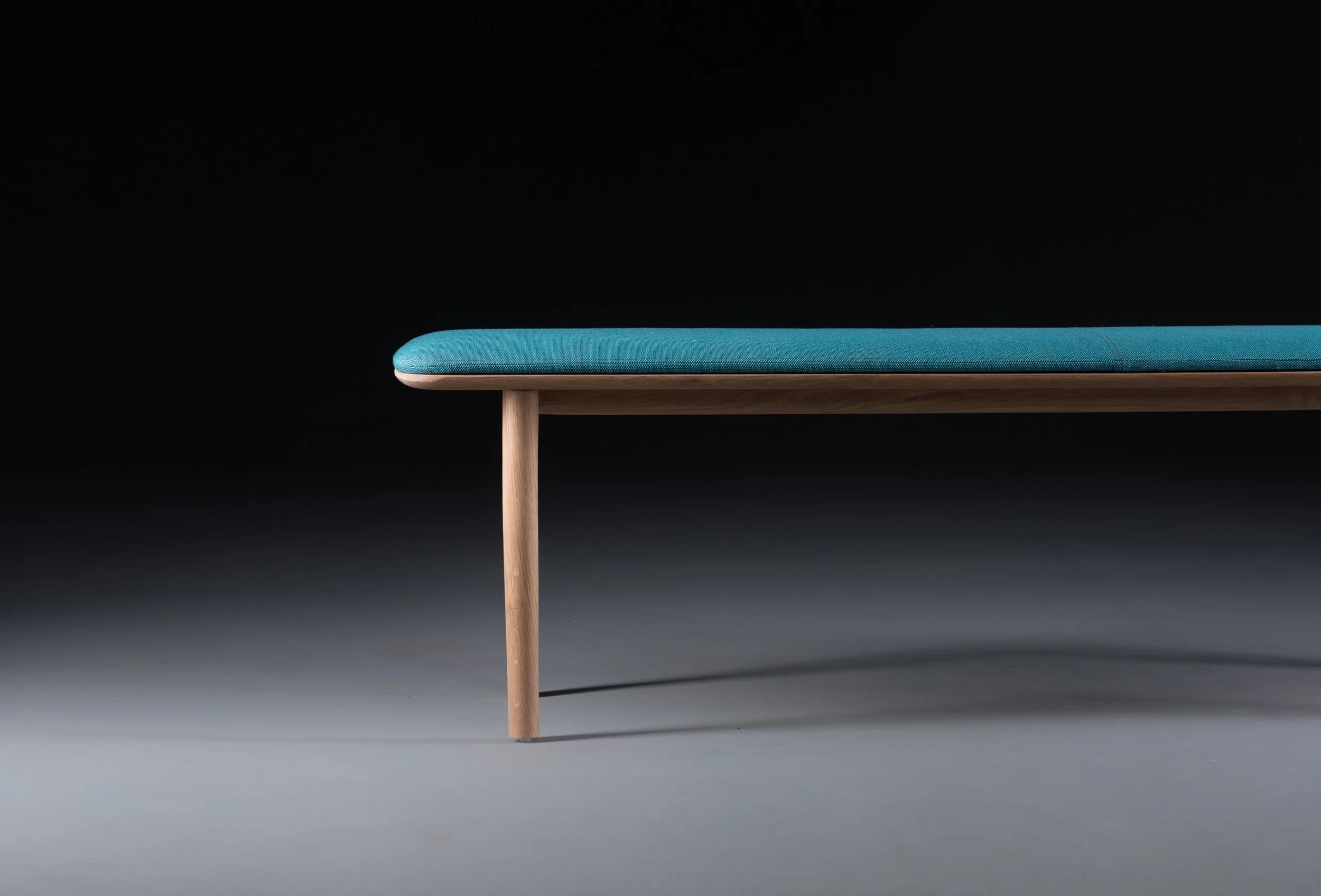 Neva bench with a solid wood frame and clean, refined lines.”