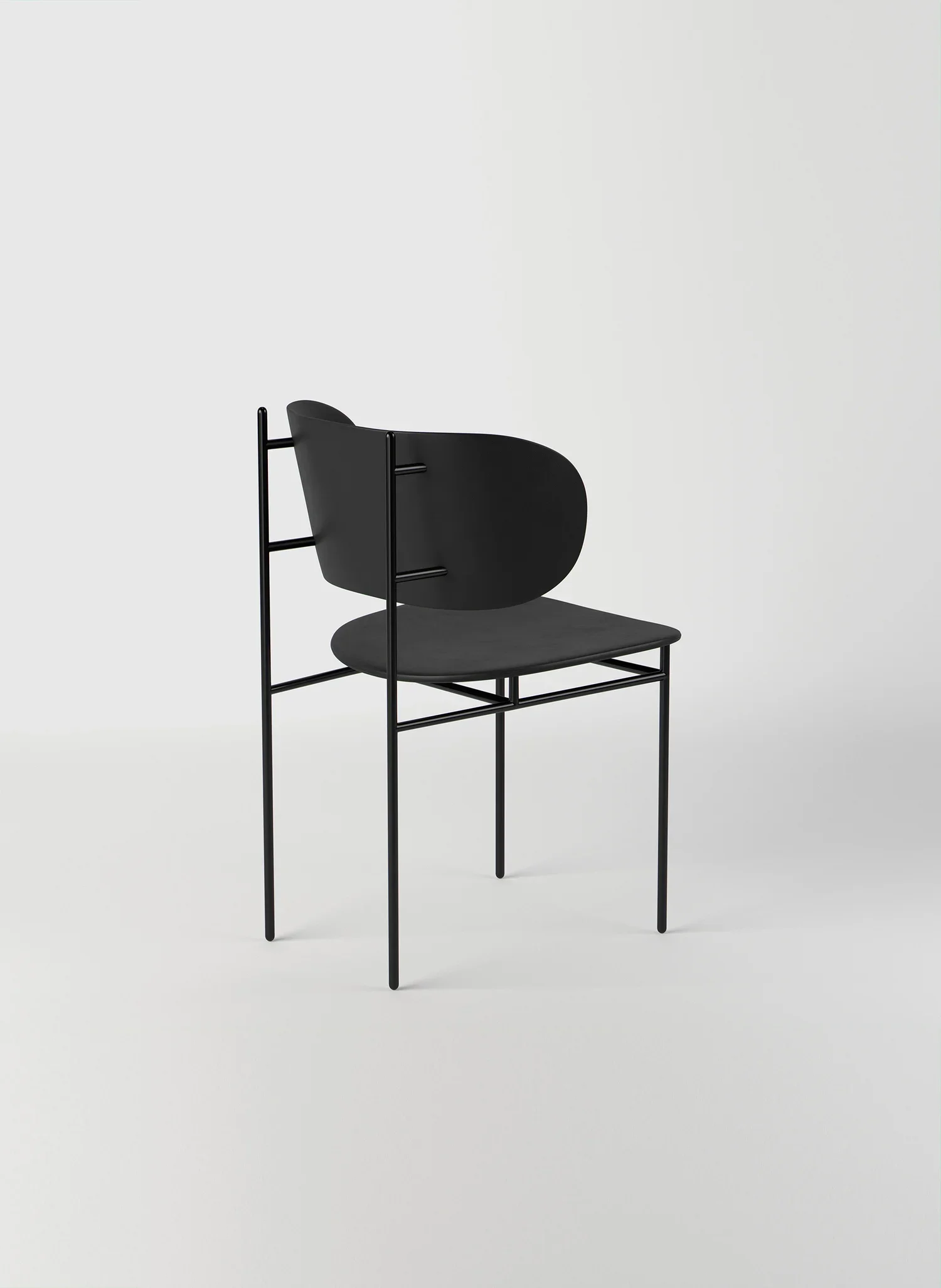 Perpendicular metal chair frame paired with embracing seat and backrest