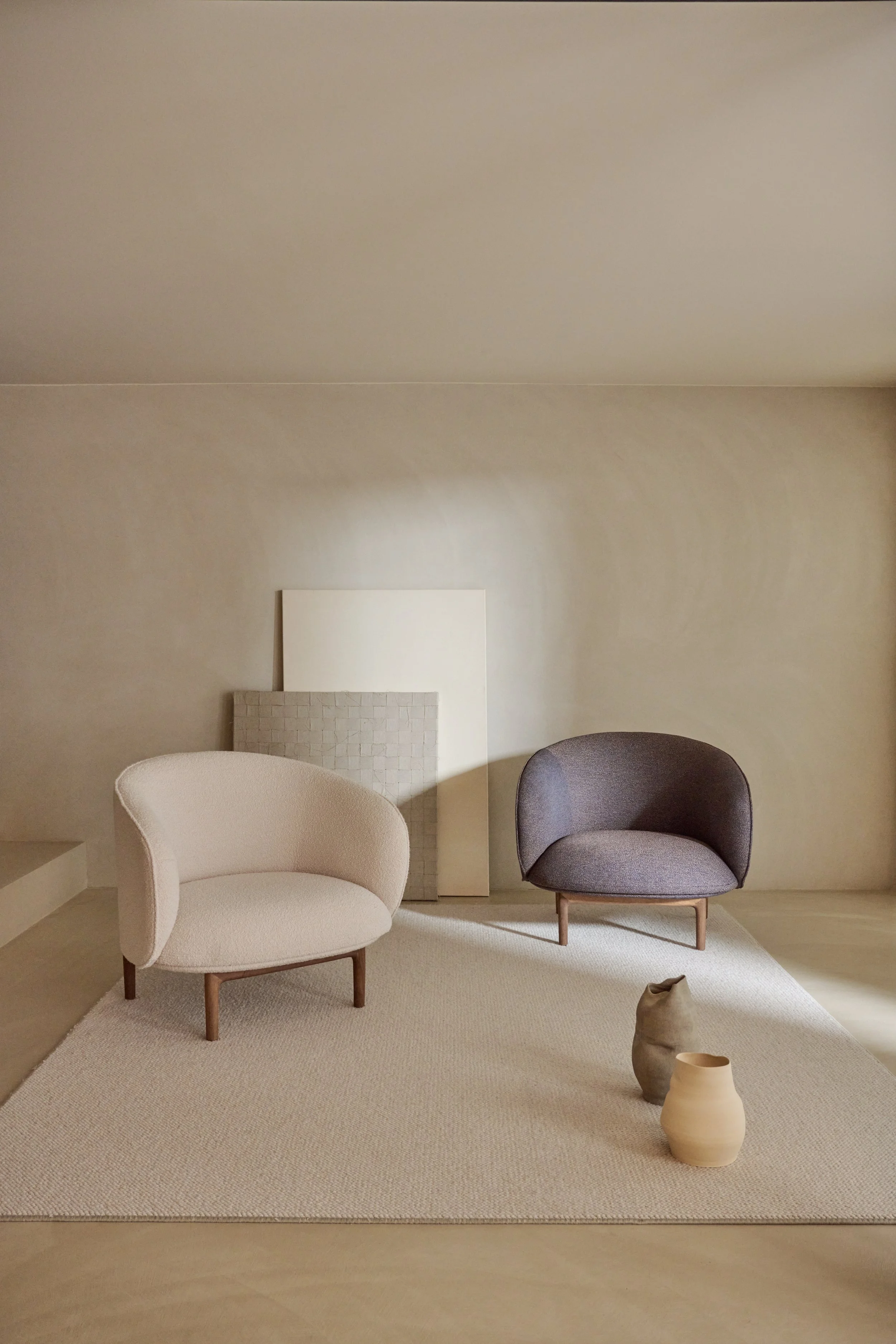 Mela Lounge Trimmed placed in a contemporary interior, providing a compact yet elegant seating option.