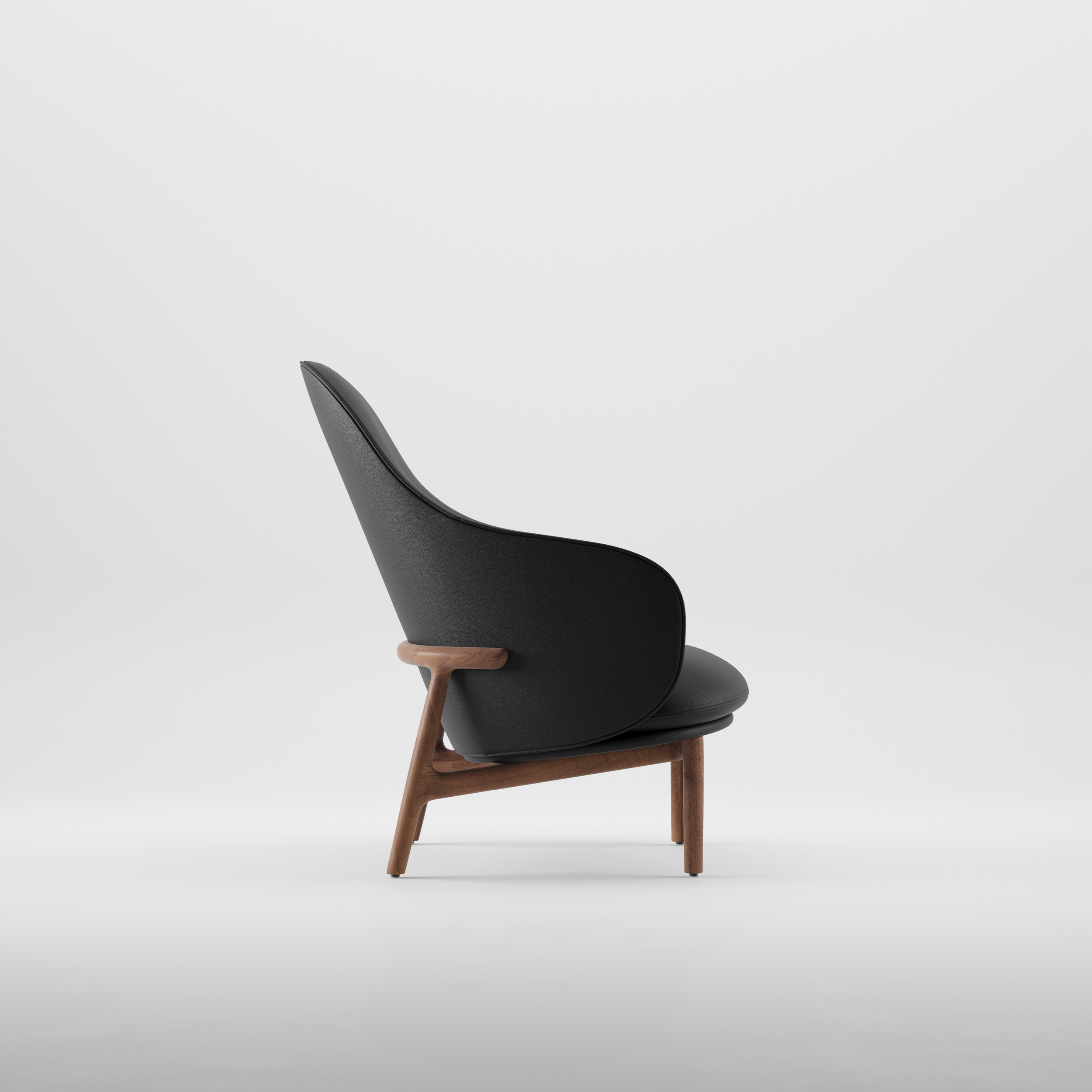 Mela lounge chair featuring flowing upholstered forms and a precisely crafted wooden base.