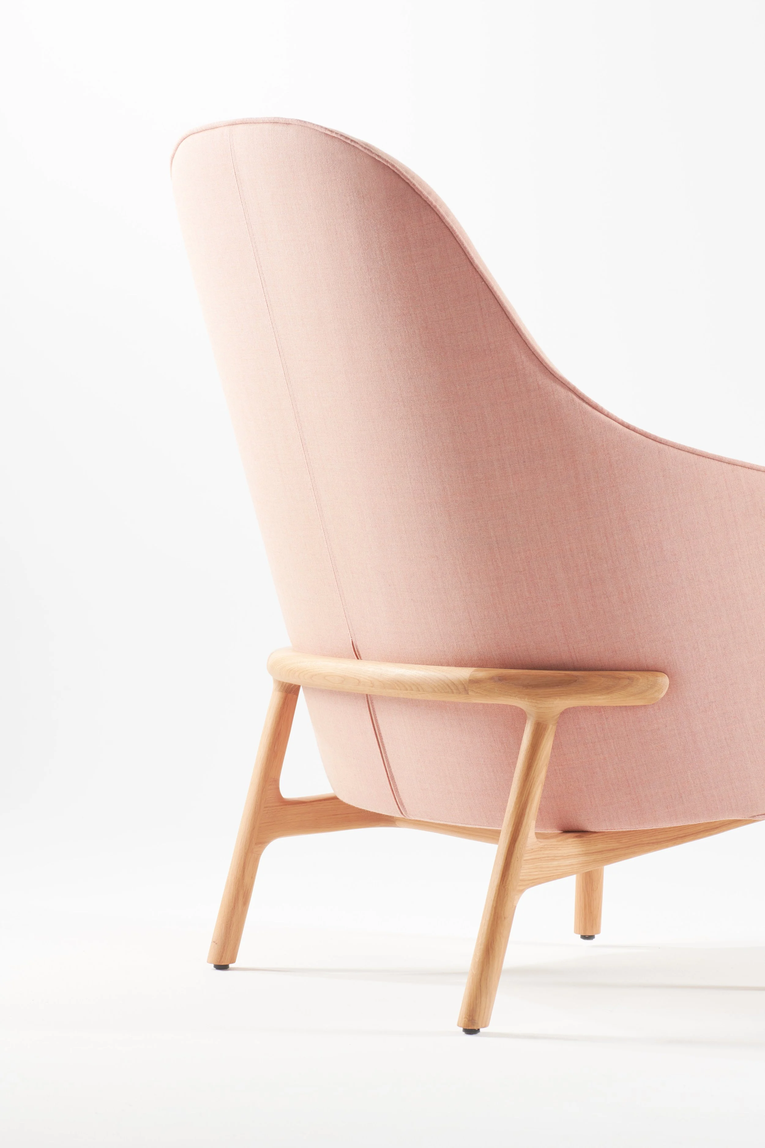 Mela lounge collection featuring an armchair, lounge chair, and sofa with upholstered seats and solid wood frames.