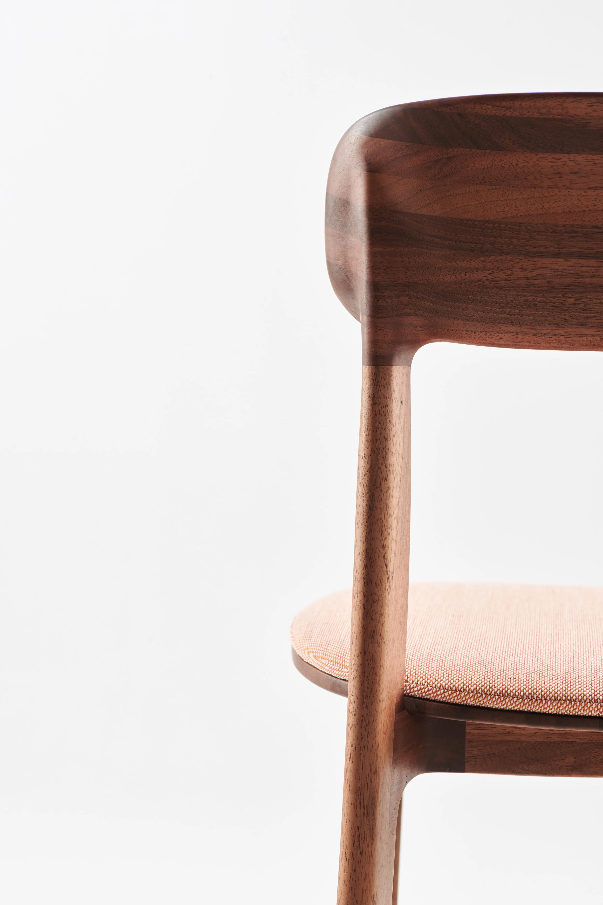 Close-up of Tanka Chair wood texture and upholstery detail