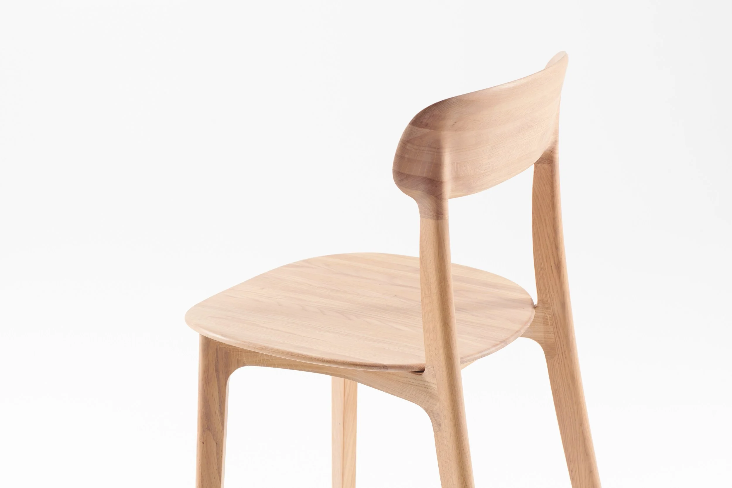 Tanka Chair with elegant curved wooden back legs