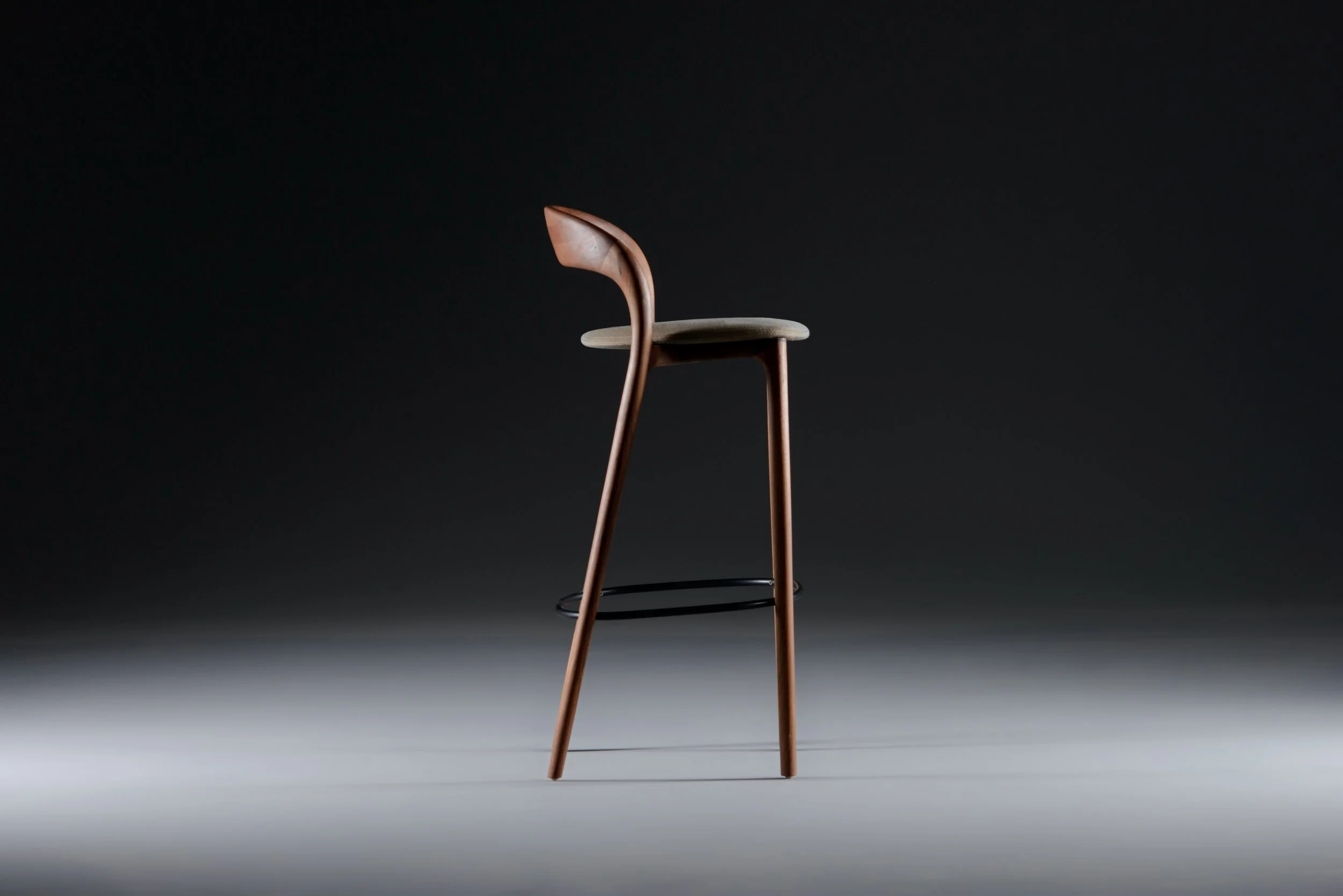 Neva Light bar chair in bar height with a solid wood structure and upholstered seat.