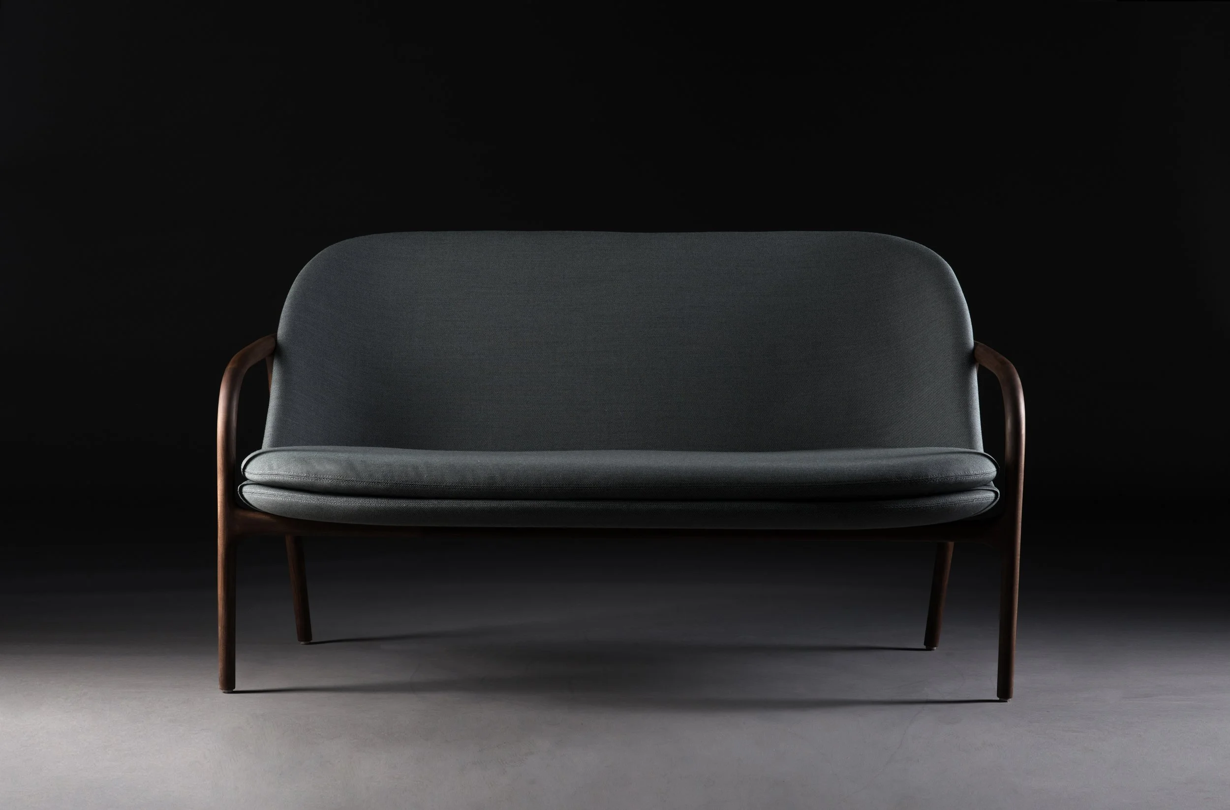 Neva Sofa Trimmed with low backrest and sculpted wooden frame