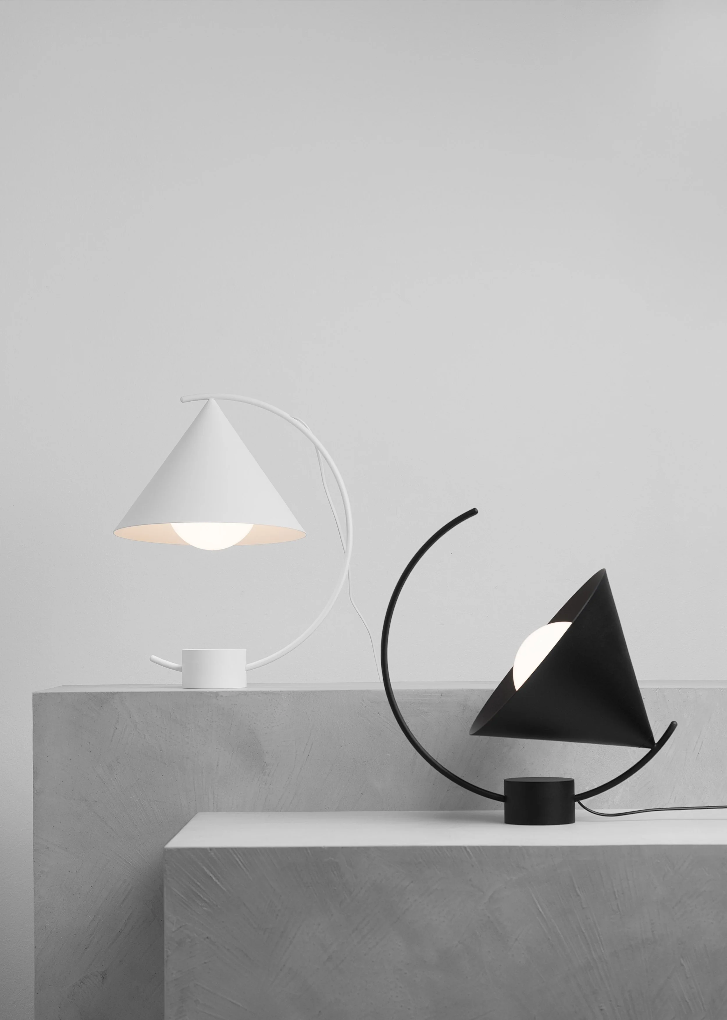 Meridian table lamp by Ferm Living, designed with clean geometric shapes and a movable mechanism for adjustable sculptural lighting effects.