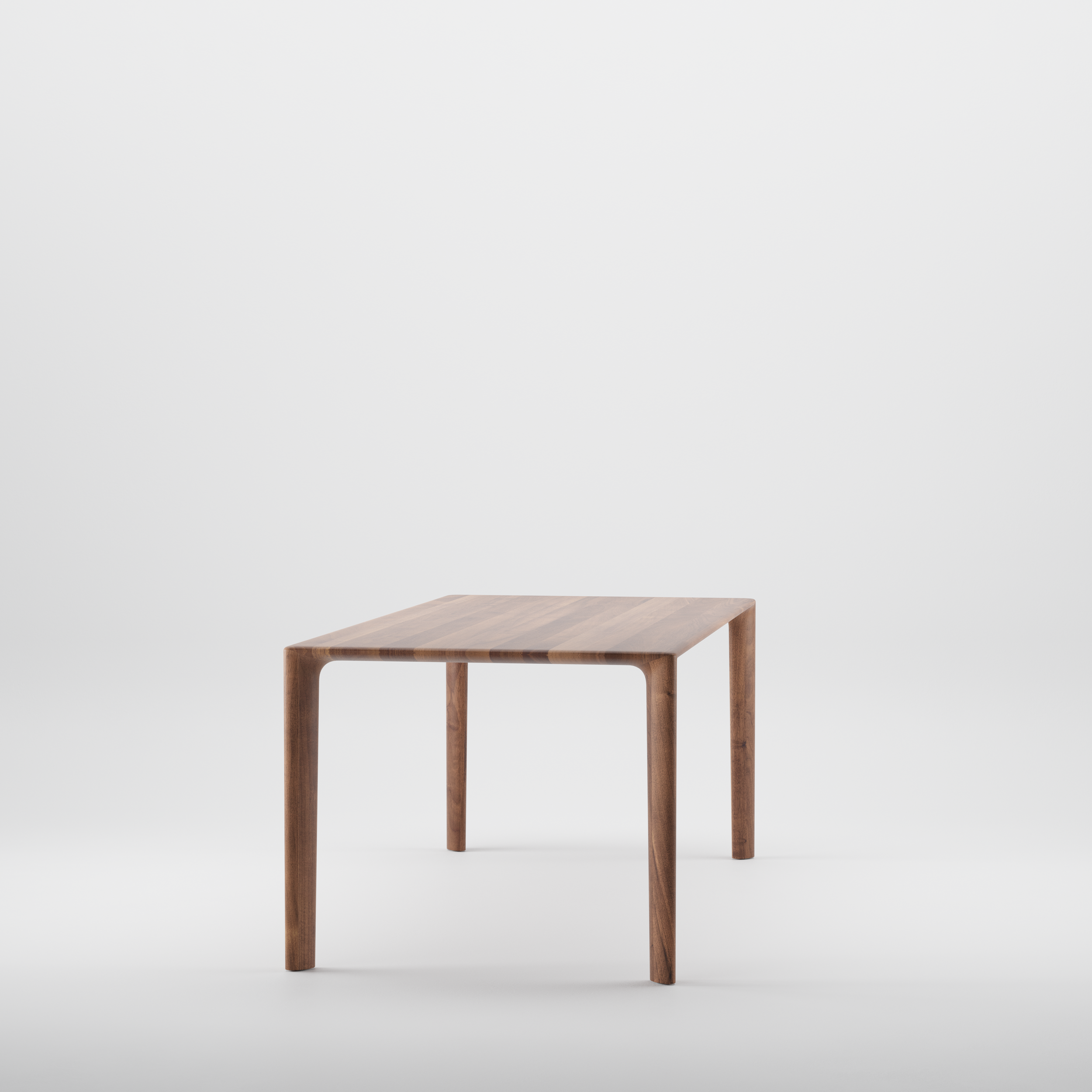 Mela Table with a solid wood top and rounded edges, featuring clean, balanced lines and refined craftsmanship.