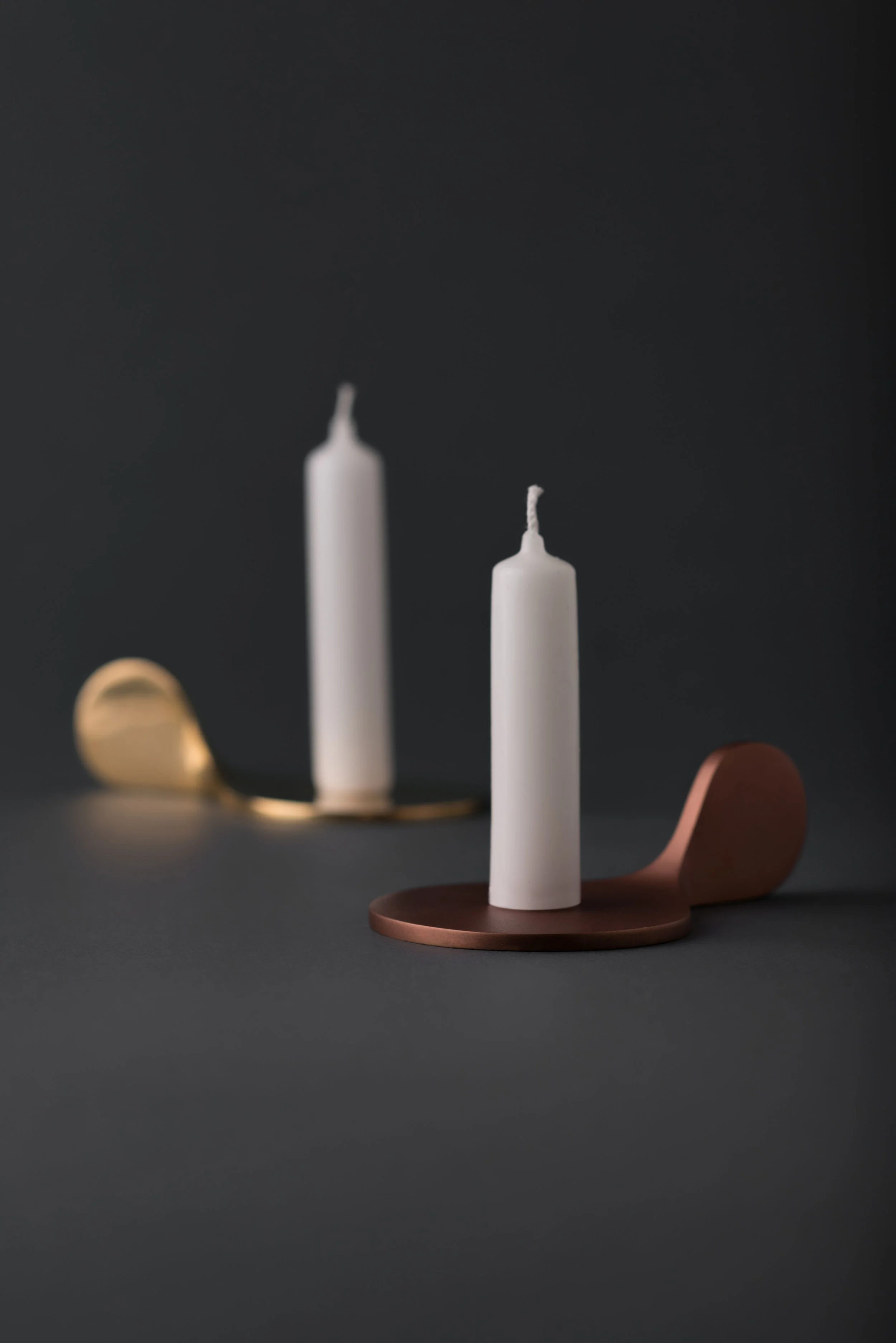 Contemporary metal candleholder with poetic, functional design