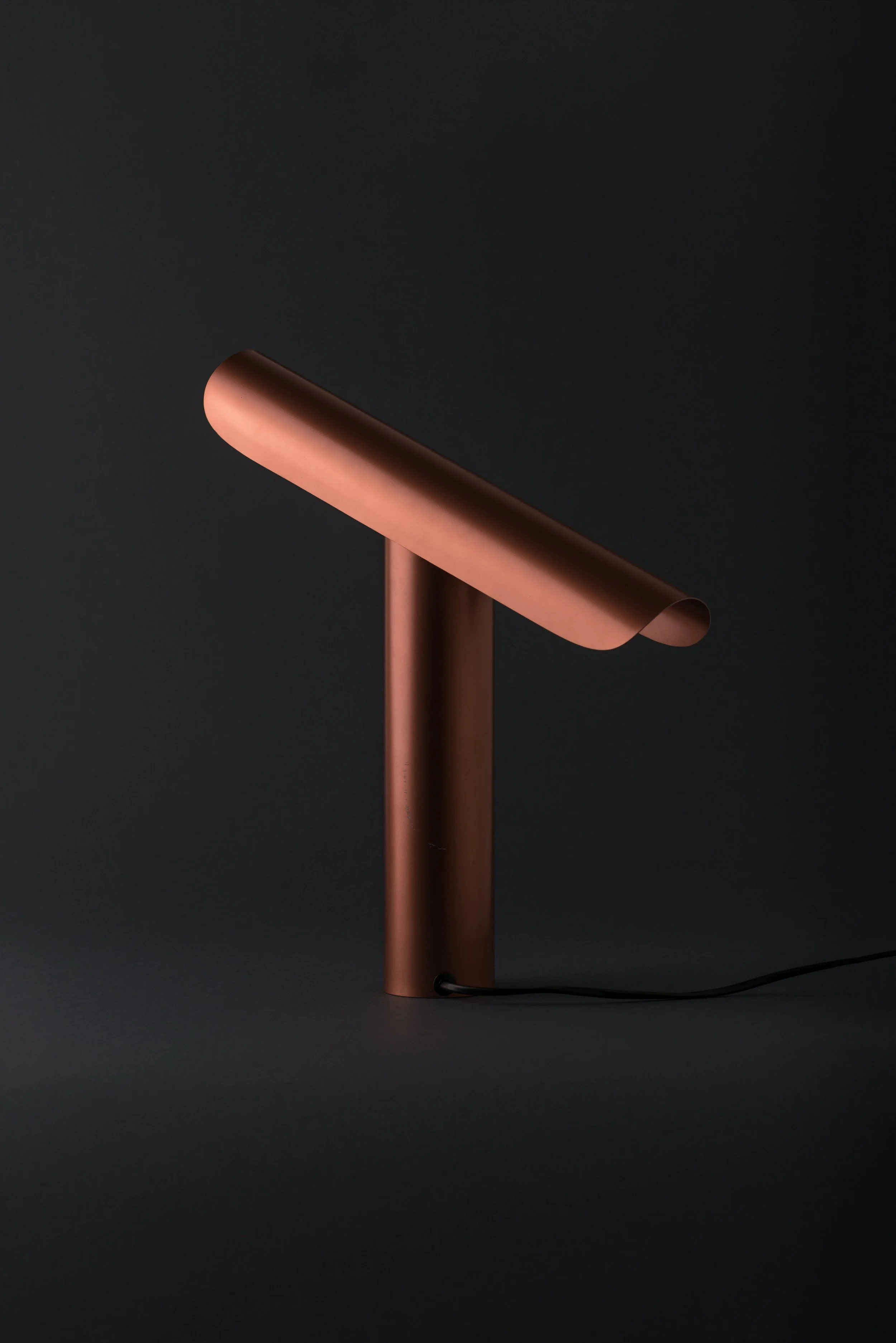 Detail of T Lamp showing its tilting mechanism, allowing adjustable light direction while maintaining a minimalist, geometric design.