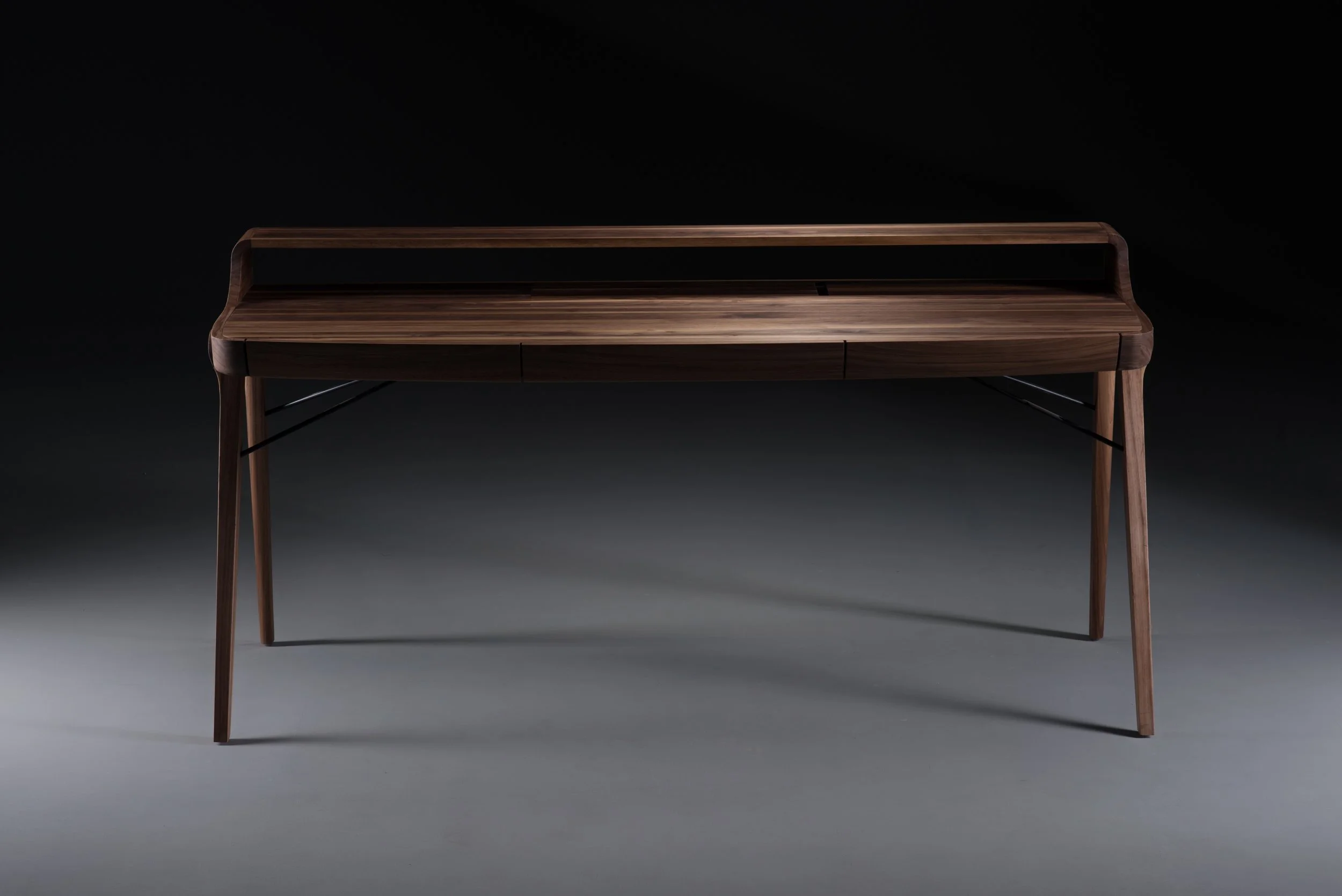 Picard Desk with soft-edged wooden body and elegant lateral legs