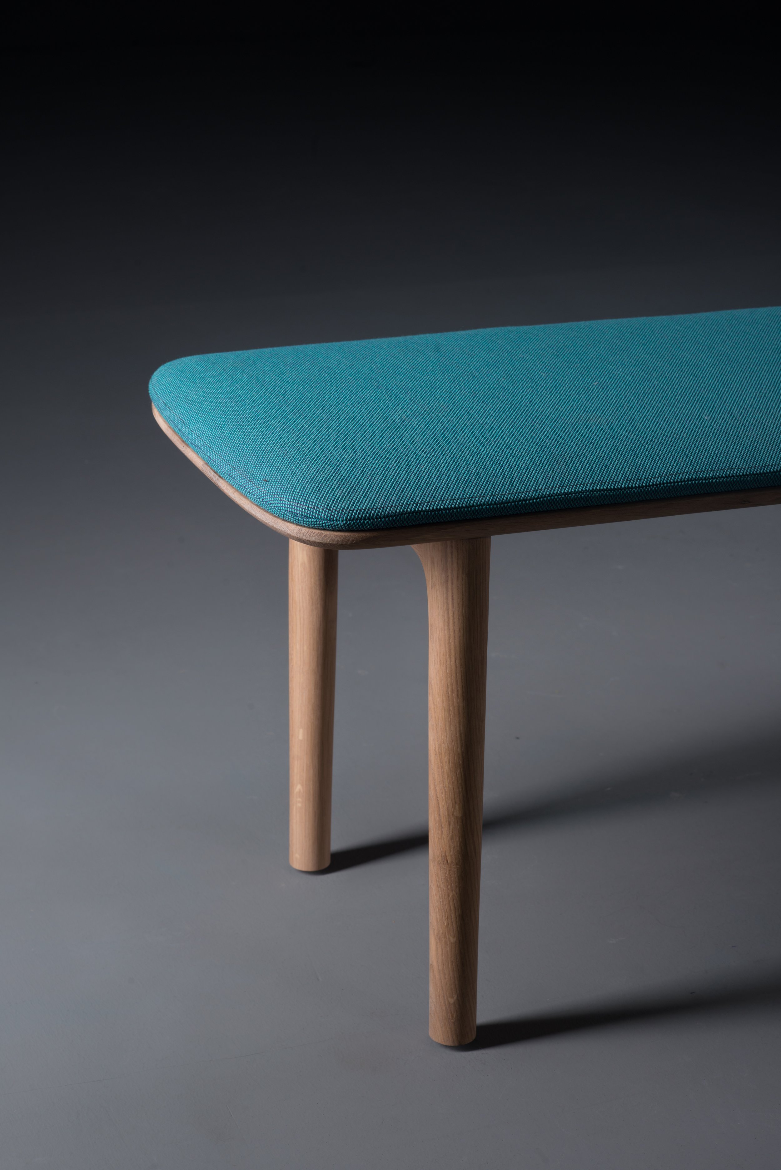 Neva bench with a solid wood frame and matching wooden seat.