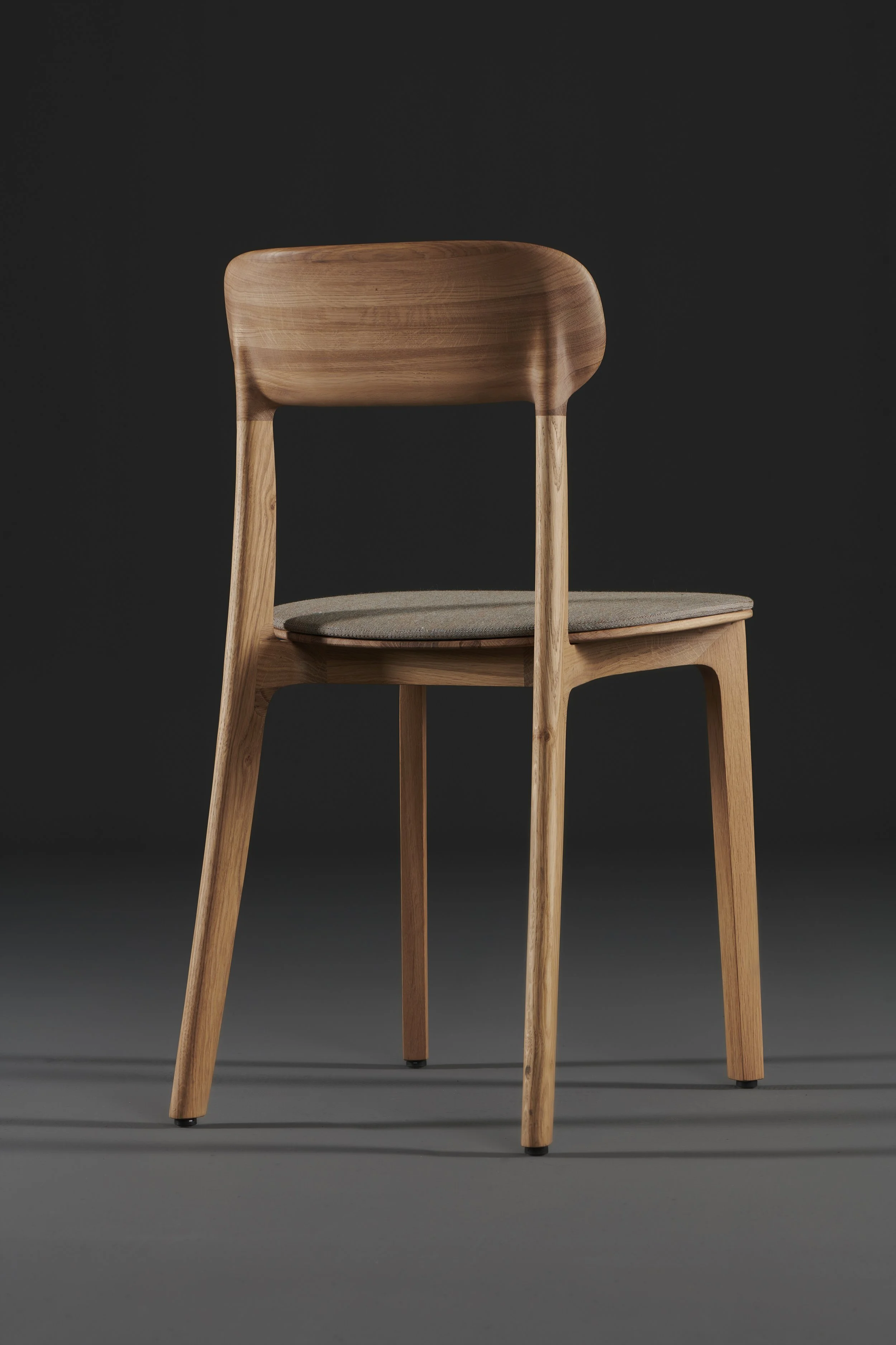 Tanka Chair with elegant curved wooden back legs