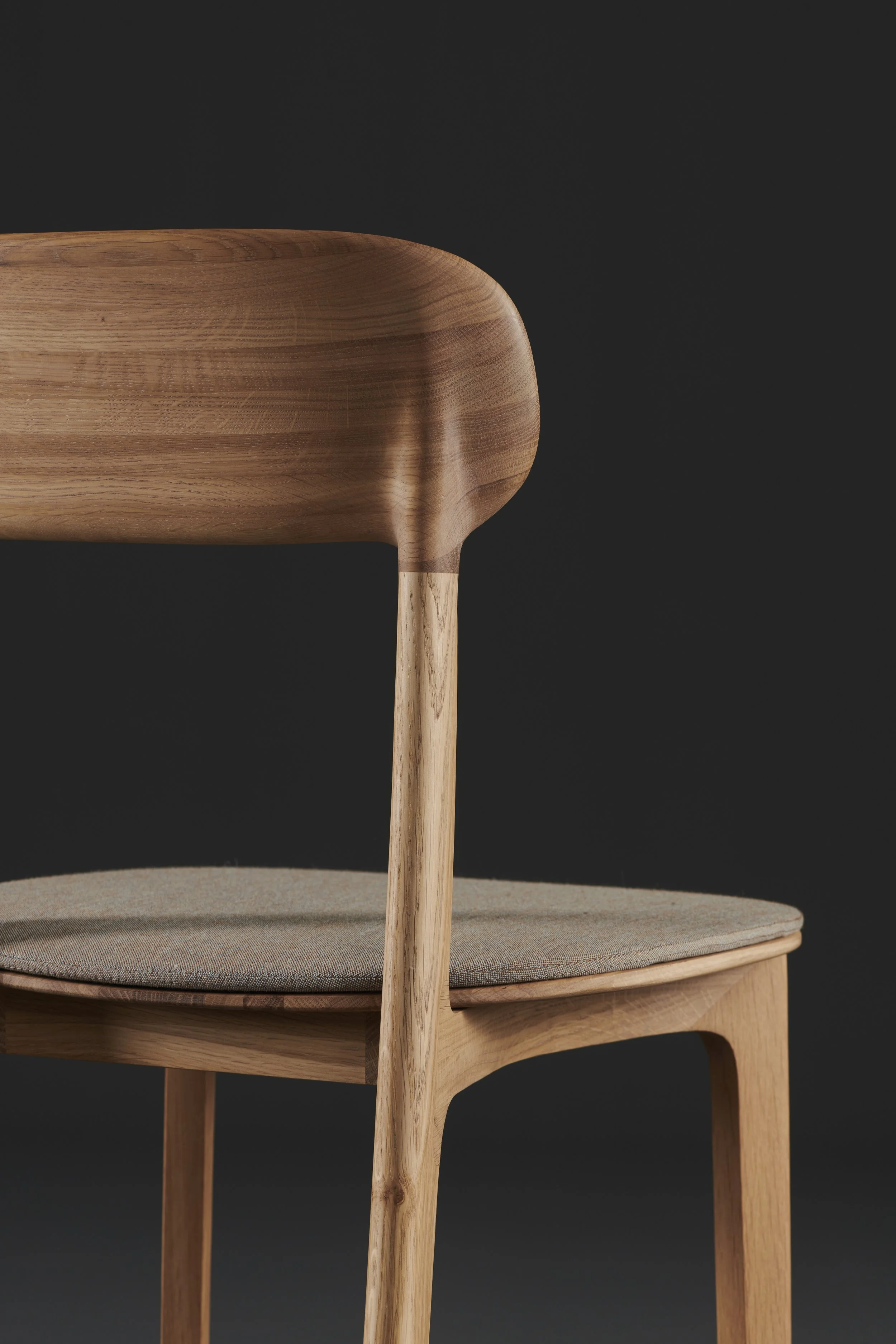 Tanka Chair with elegant curved wooden back legs