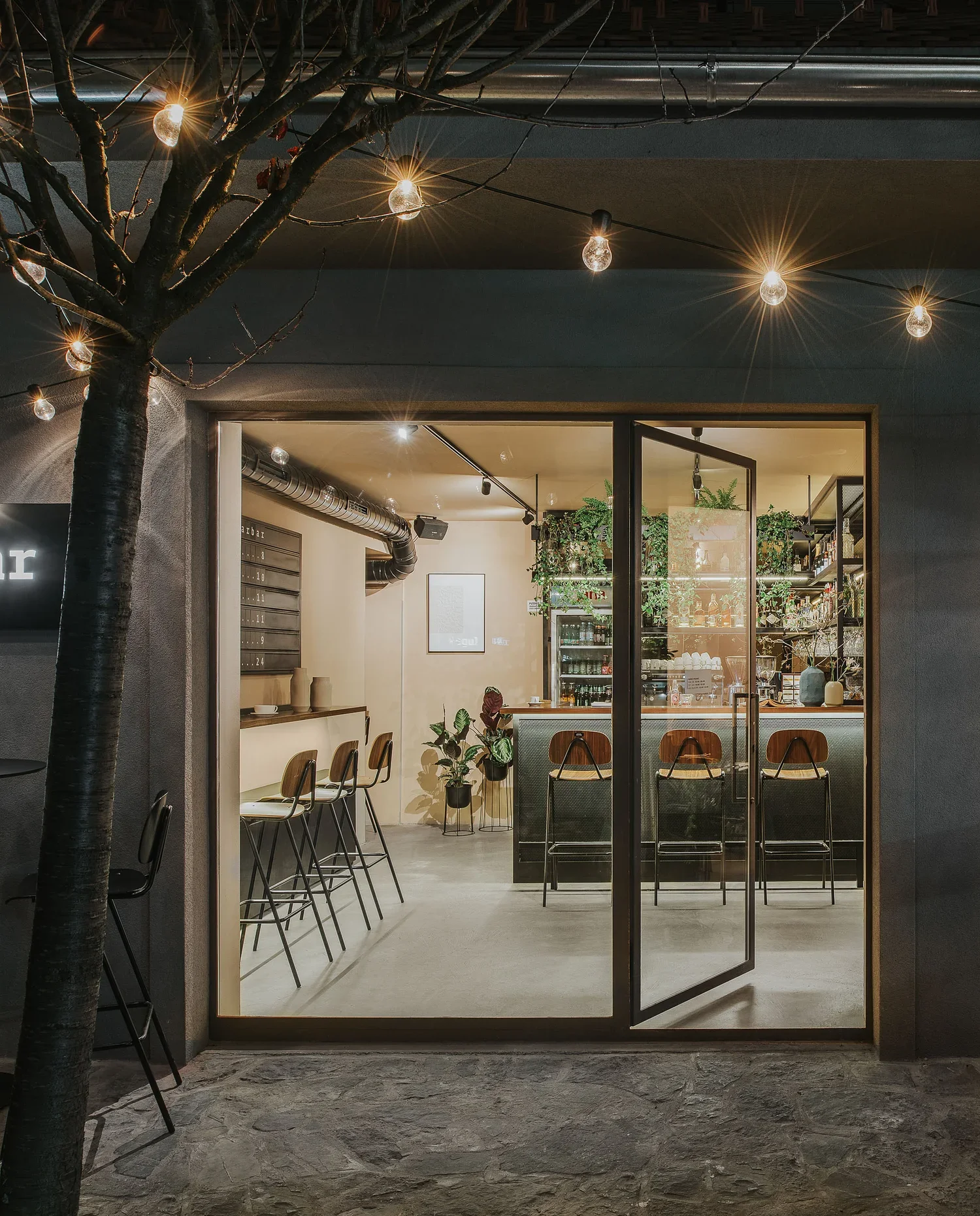 Terrace seating at Regular Bar overlooking British Square alleyway
