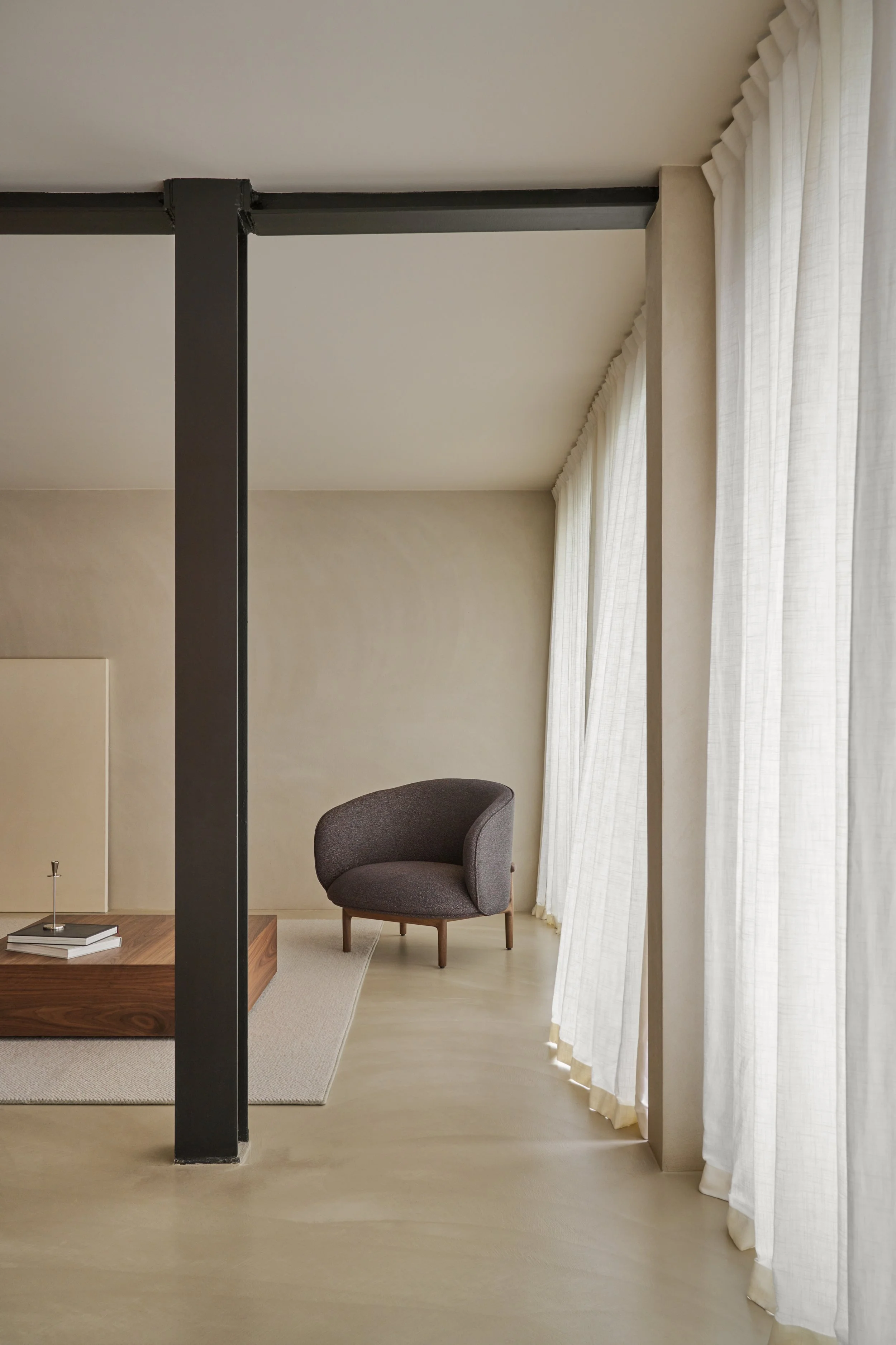 Mela Lounge Trimmed placed in a contemporary interior, providing a compact yet elegant seating option.