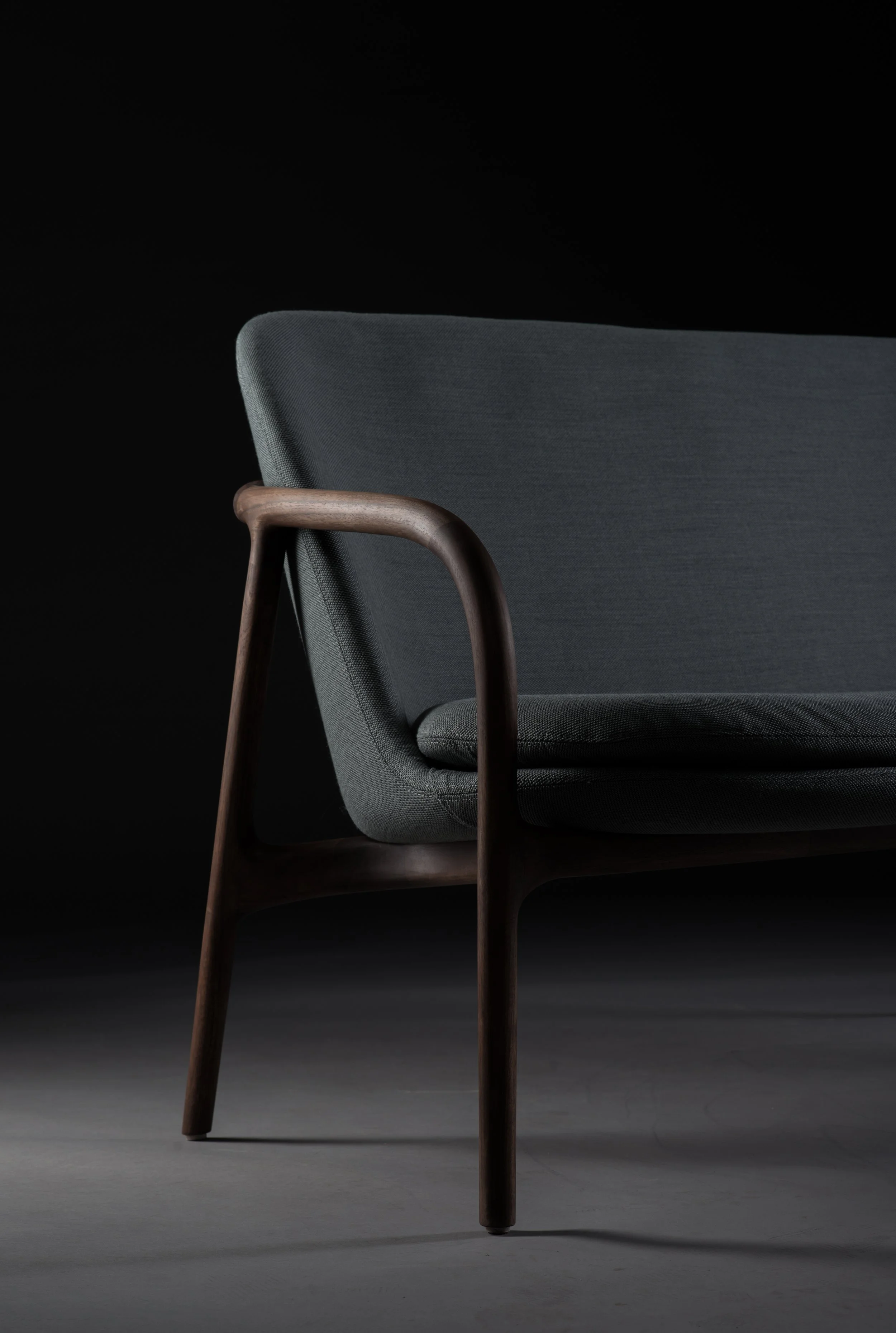 Neva Sofa Trimmed with low backrest and sculpted wooden frame