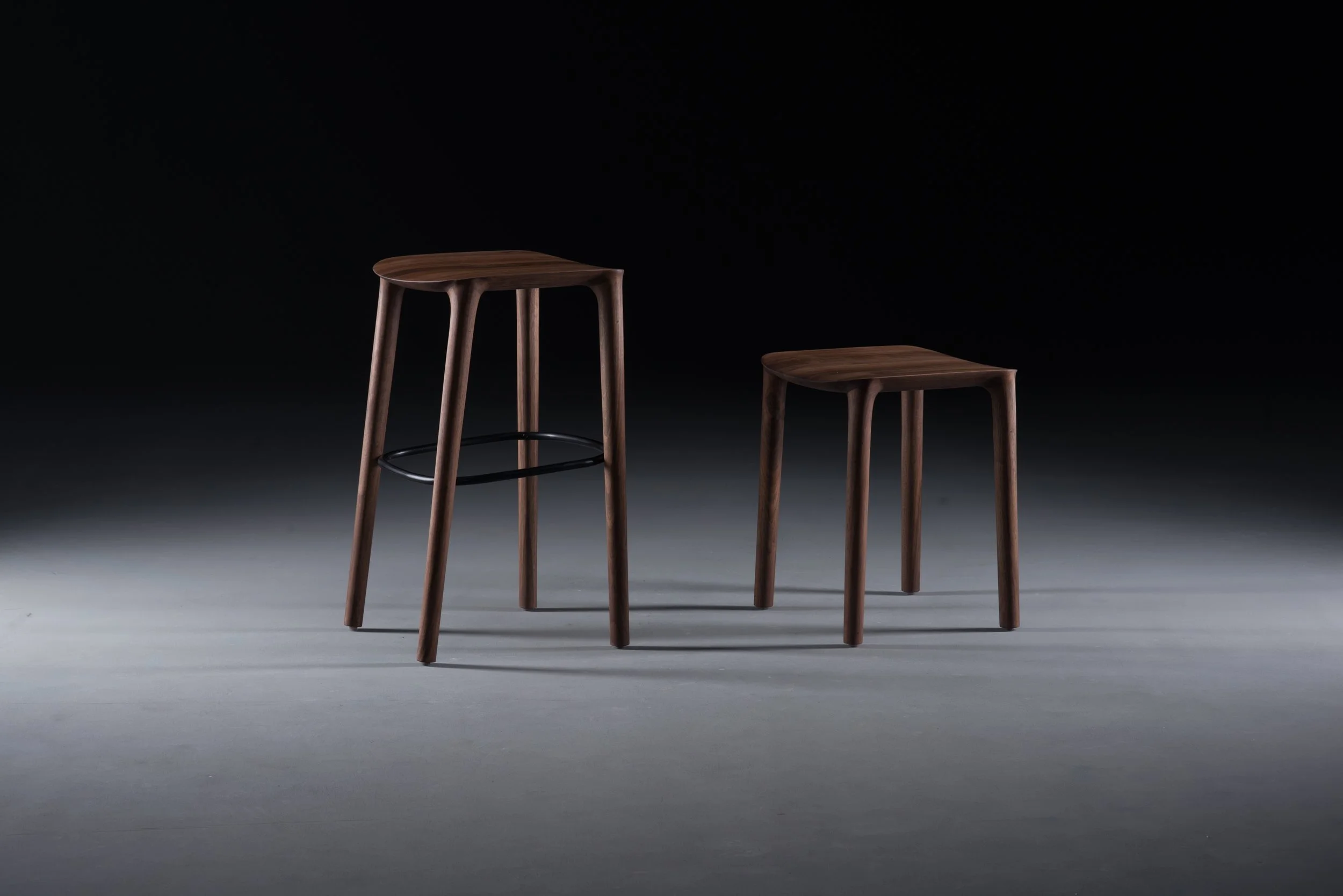Original Neva chair introduced in 2013, featuring a sculpted solid wood frame.